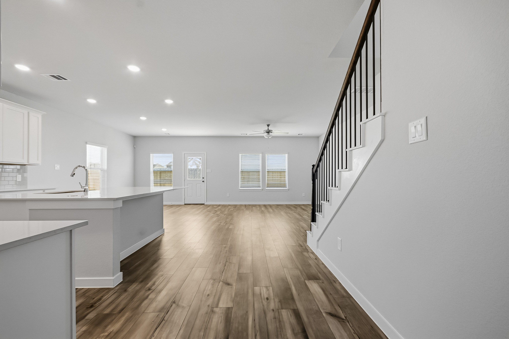 A kitchen with white cabinets.