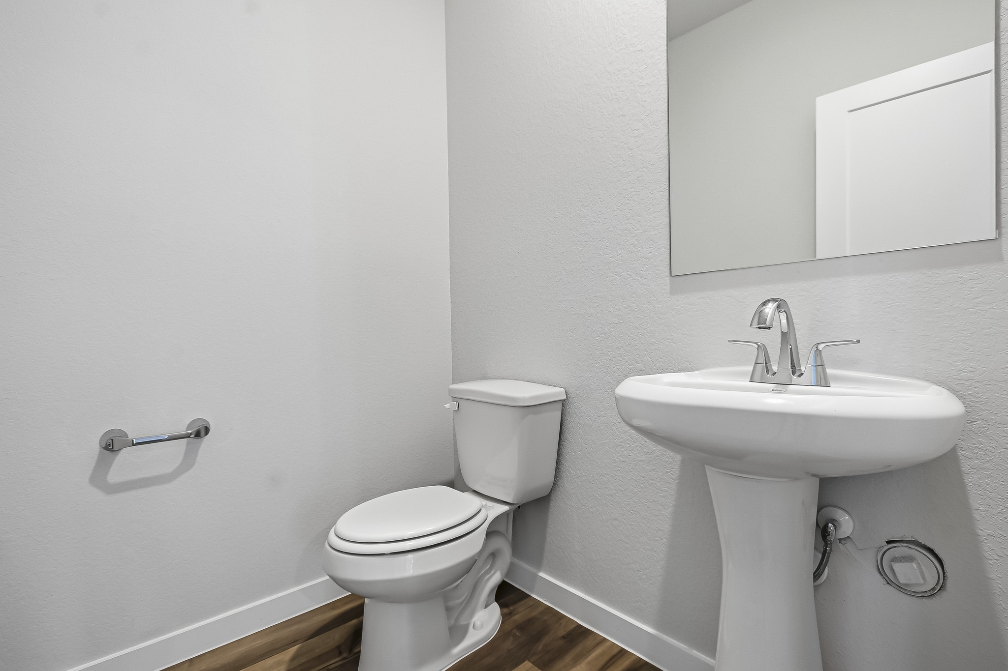 A bathroom with a toilet and sink.