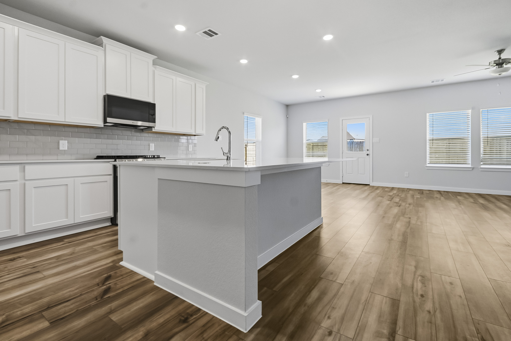 A kitchen with white cabinets.