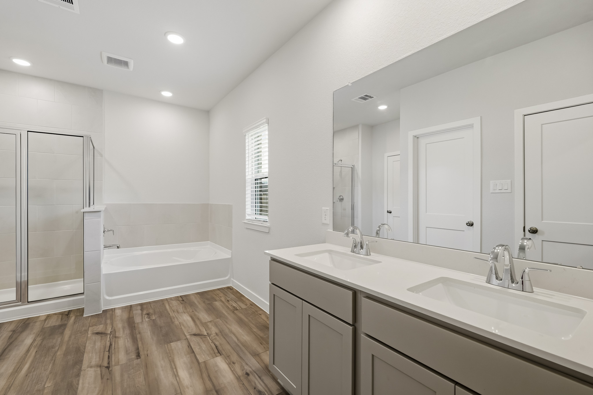 A bathroom with a tub sink and a shower.