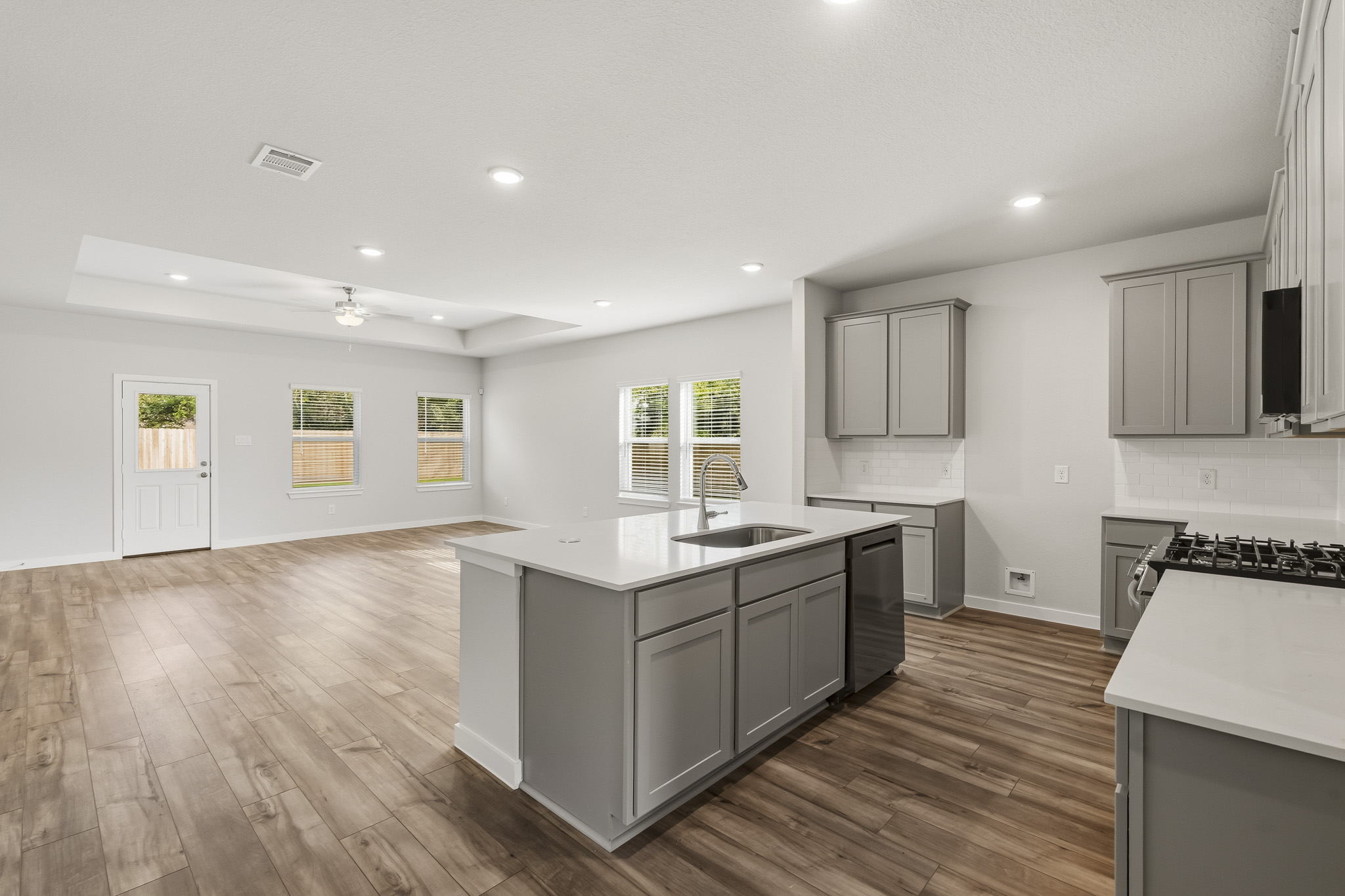 A kitchen with white cabinets.