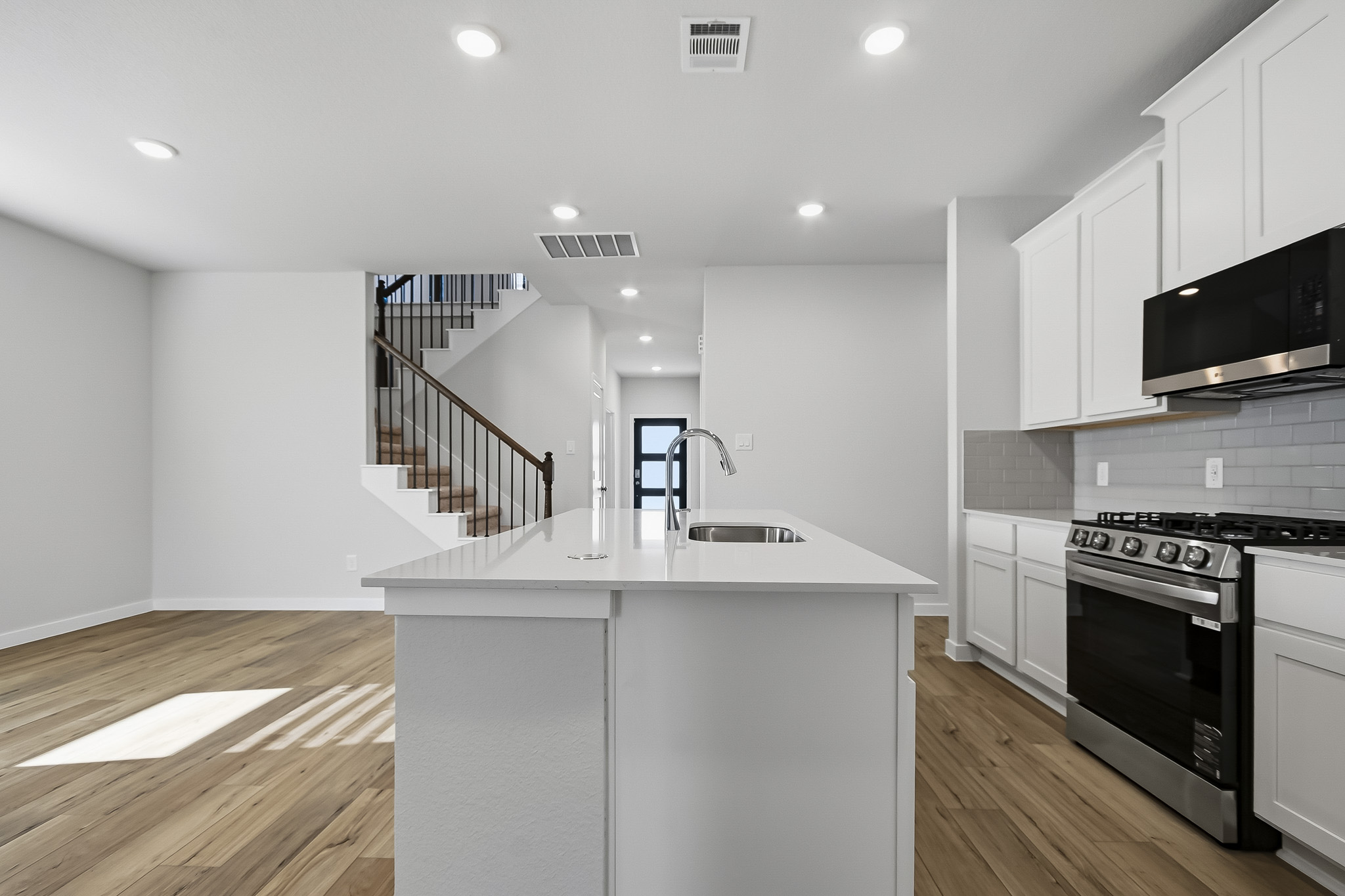A kitchen with white cabinets.
