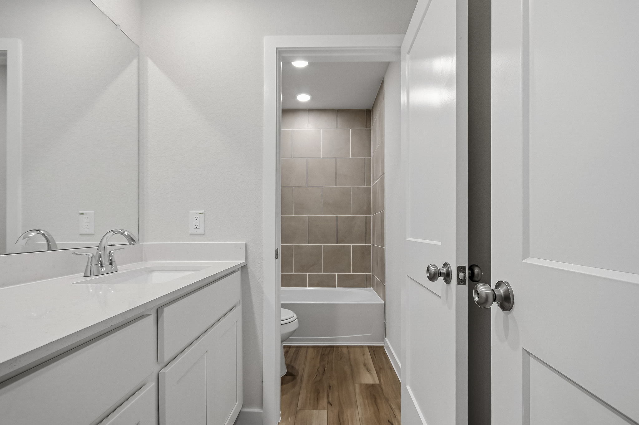 A bathroom with a tub sink and toilet.