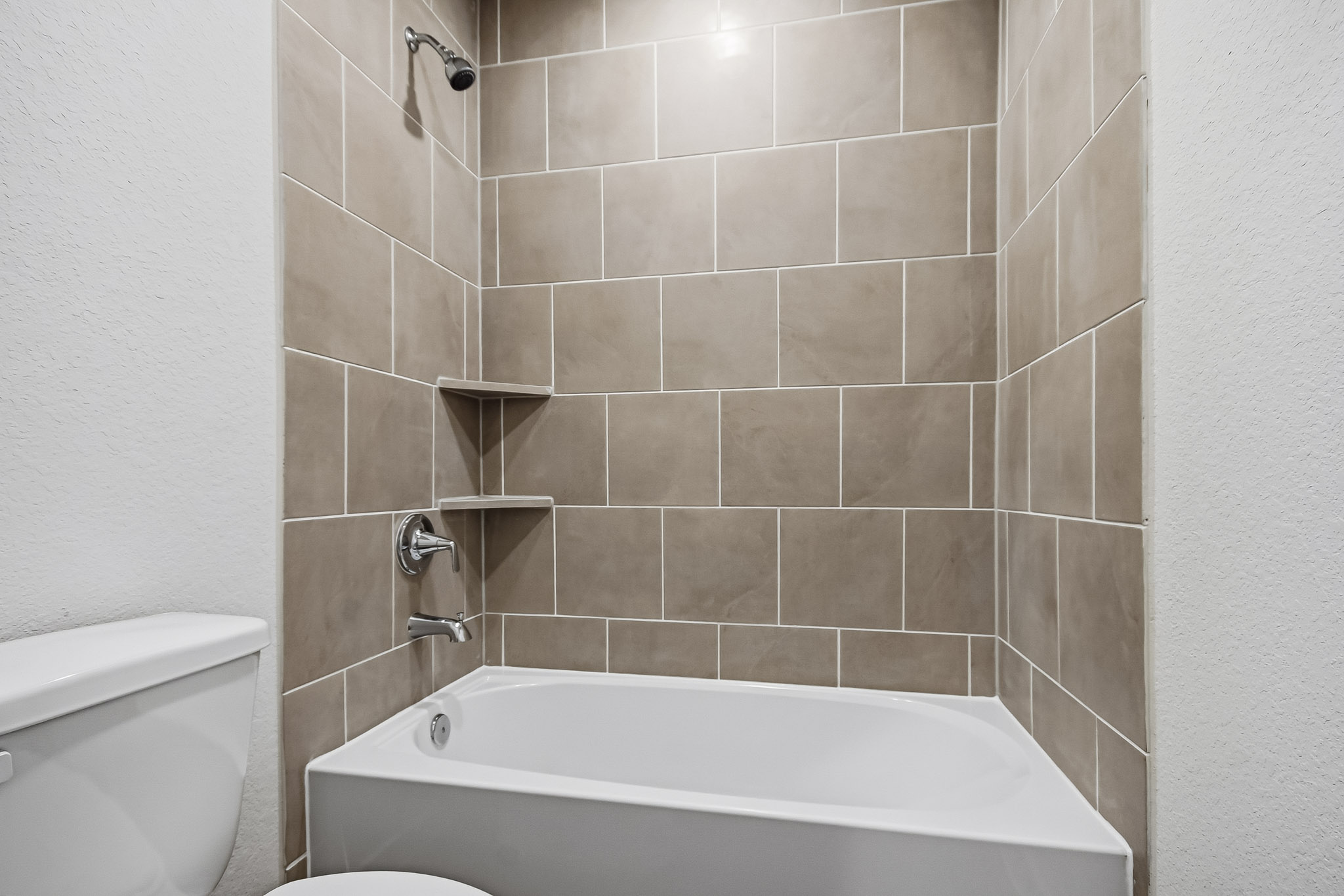A bathtub in a bathroom.