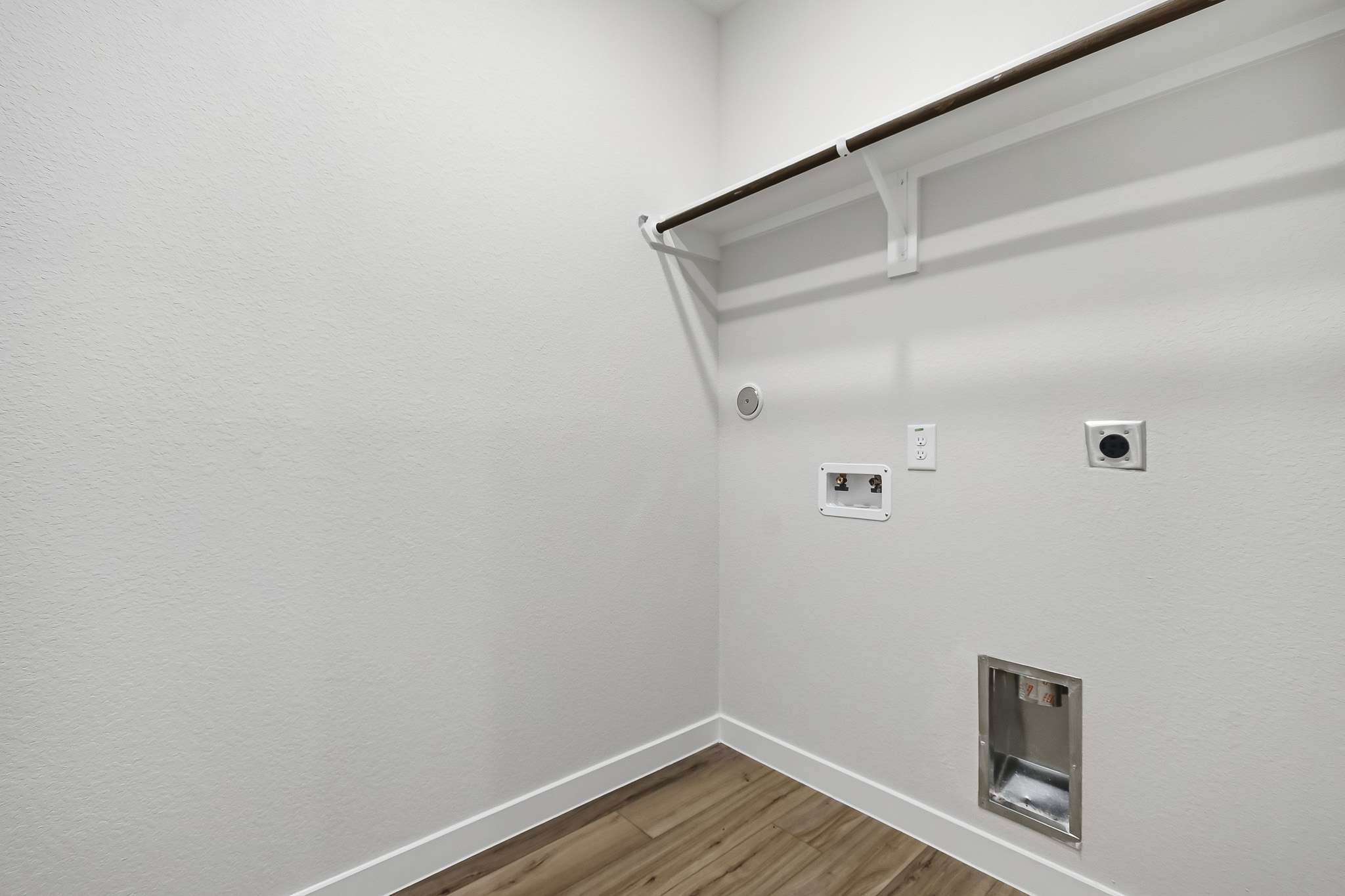 A white wall with a light fixture.