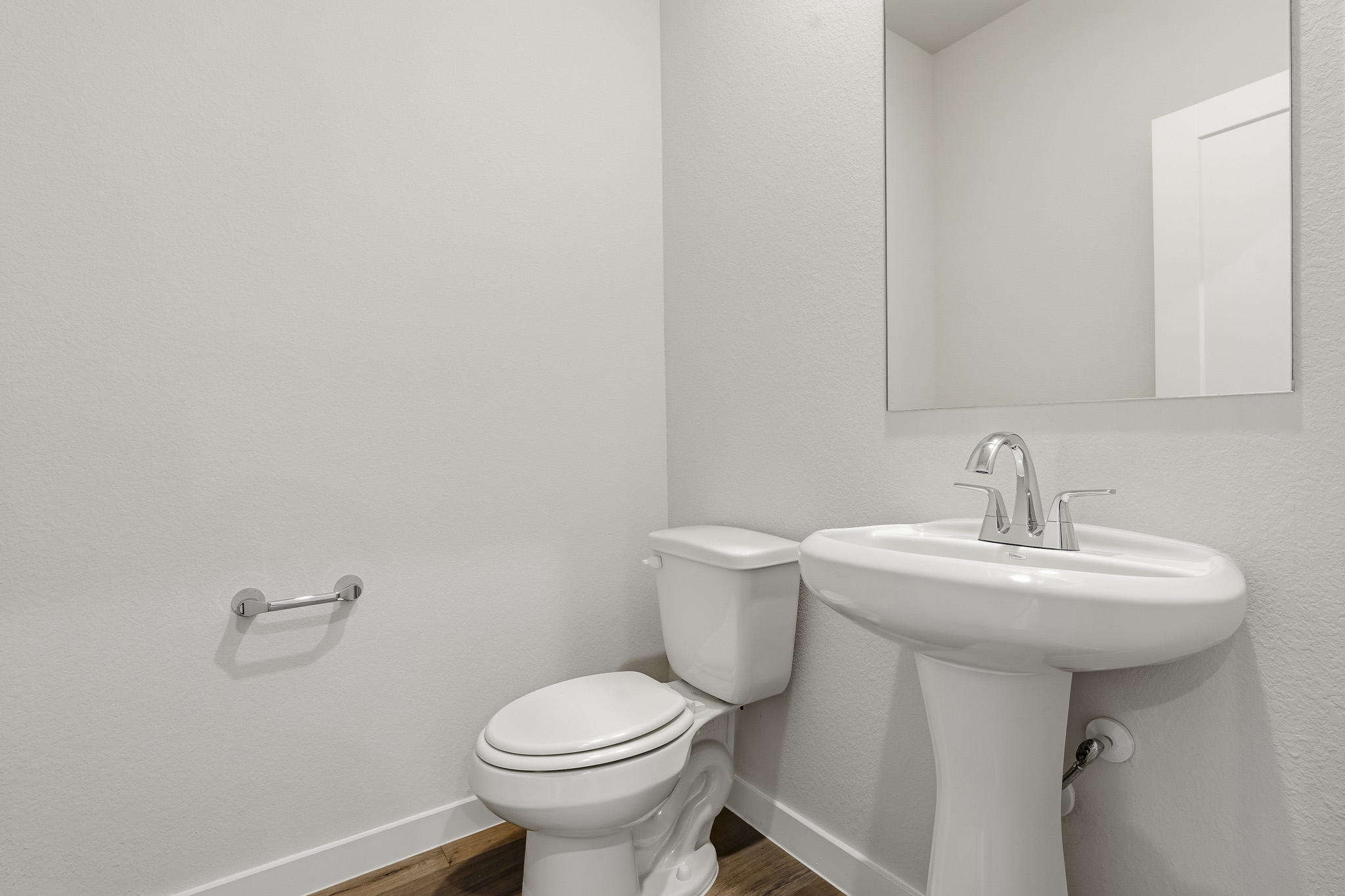 A bathroom with a toilet and sink.