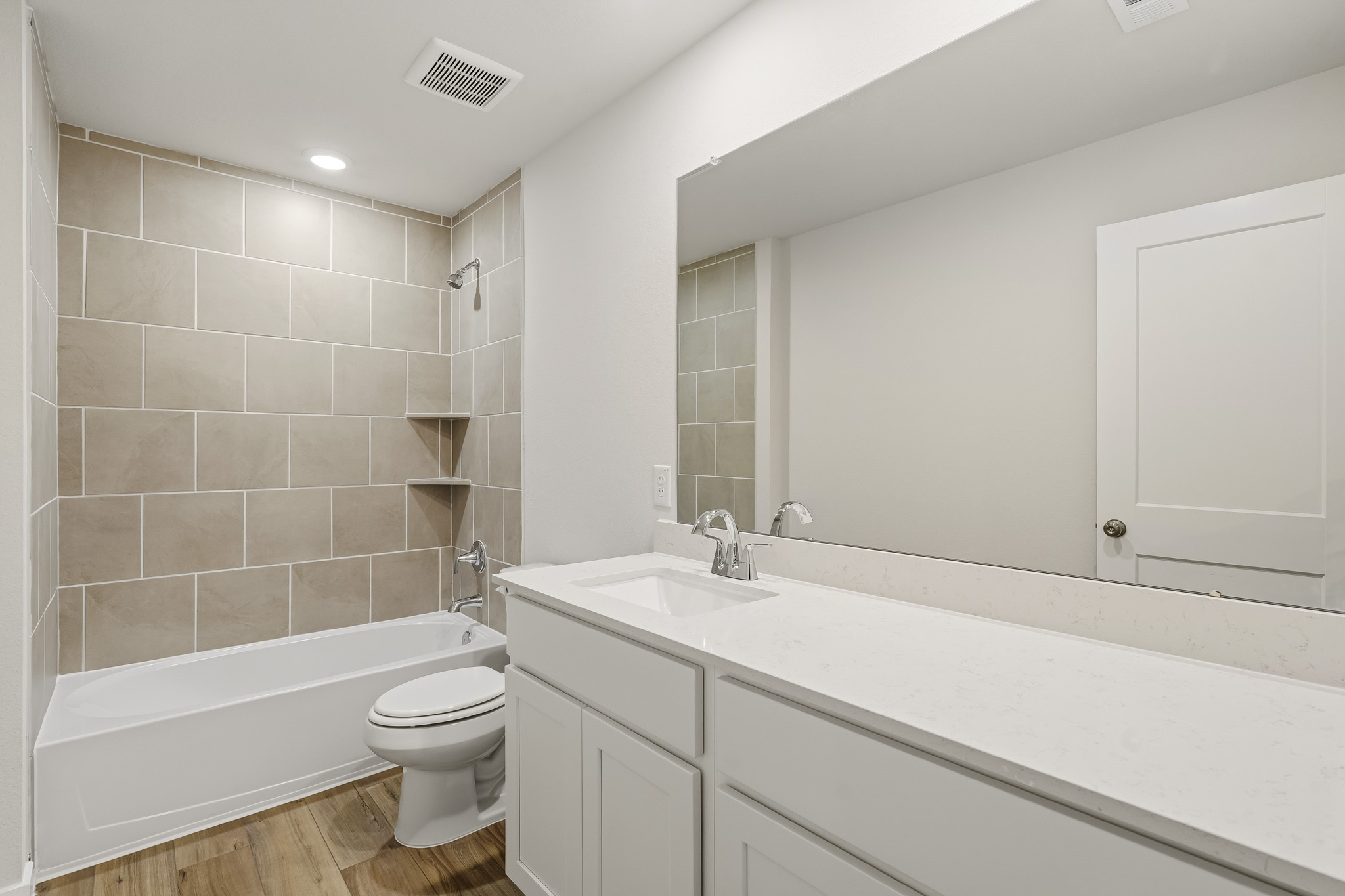 A bathroom with a tub sink and toilet.