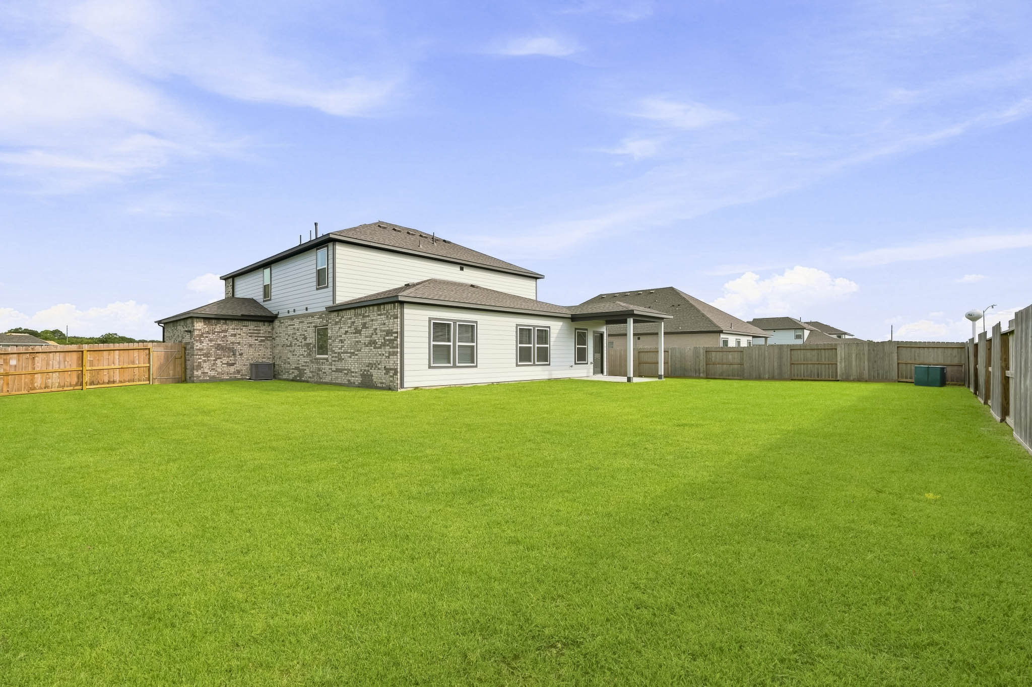 A house with a fence and grass with Castle Solitude in the background.