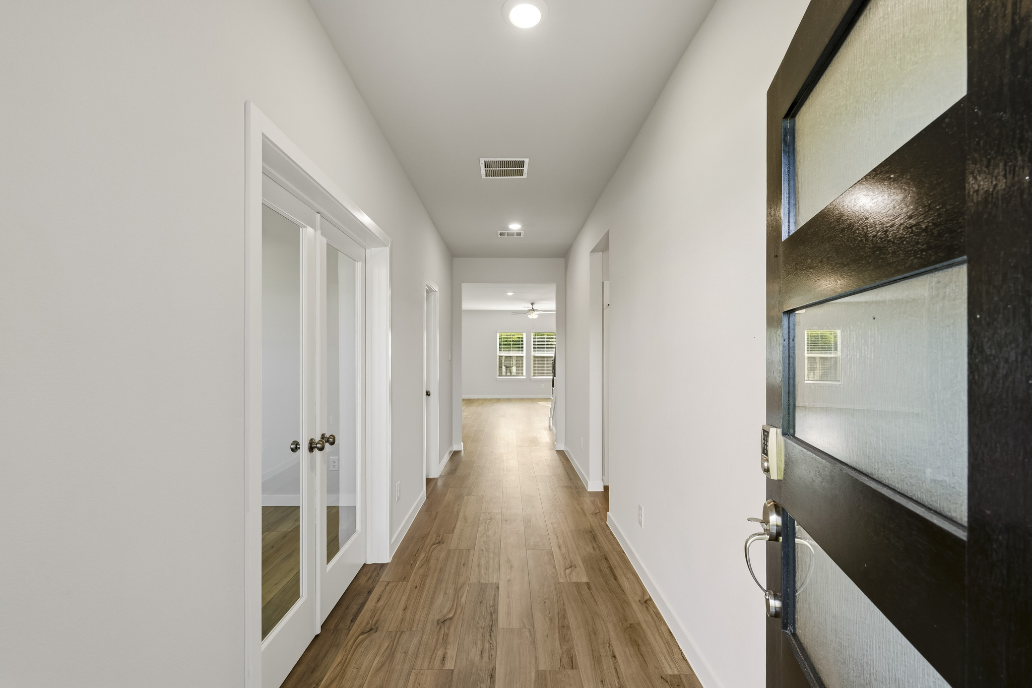 A hallway with white doors.