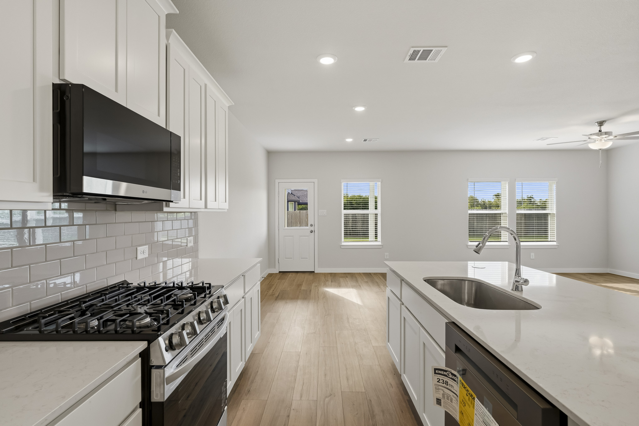 A kitchen with white cabinets.
