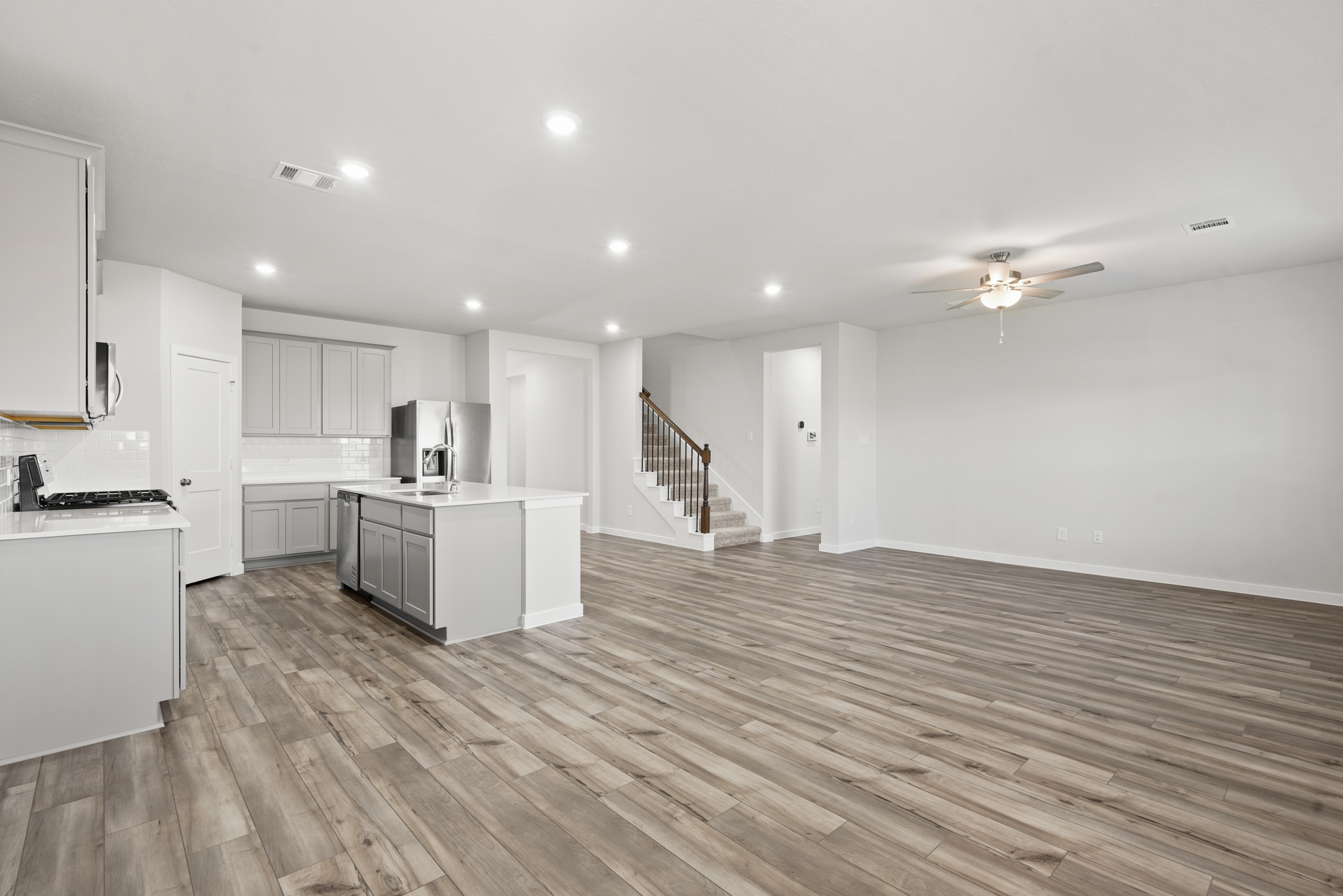 A large kitchen with white cabinets.