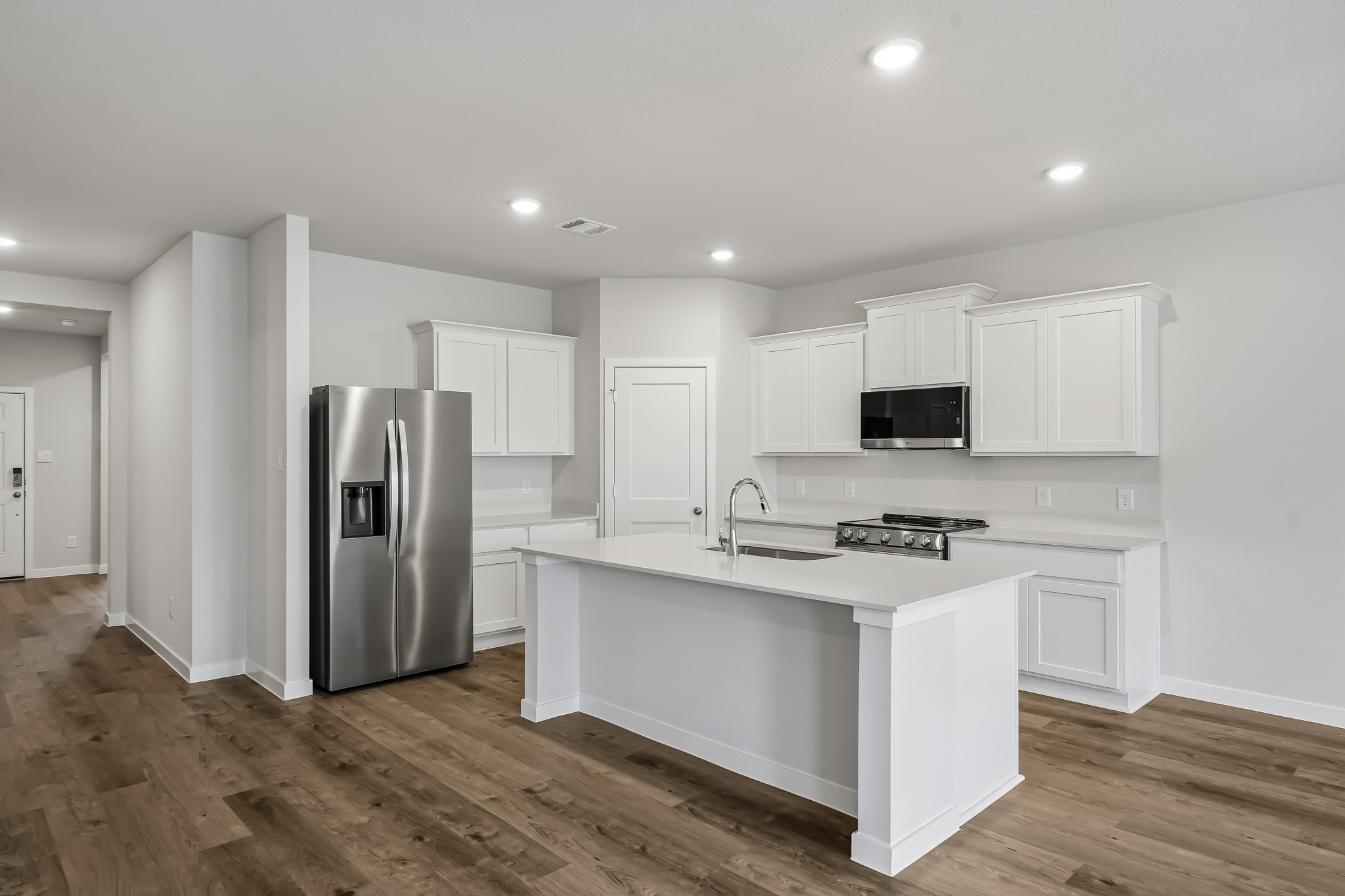 A kitchen with white cabinets.