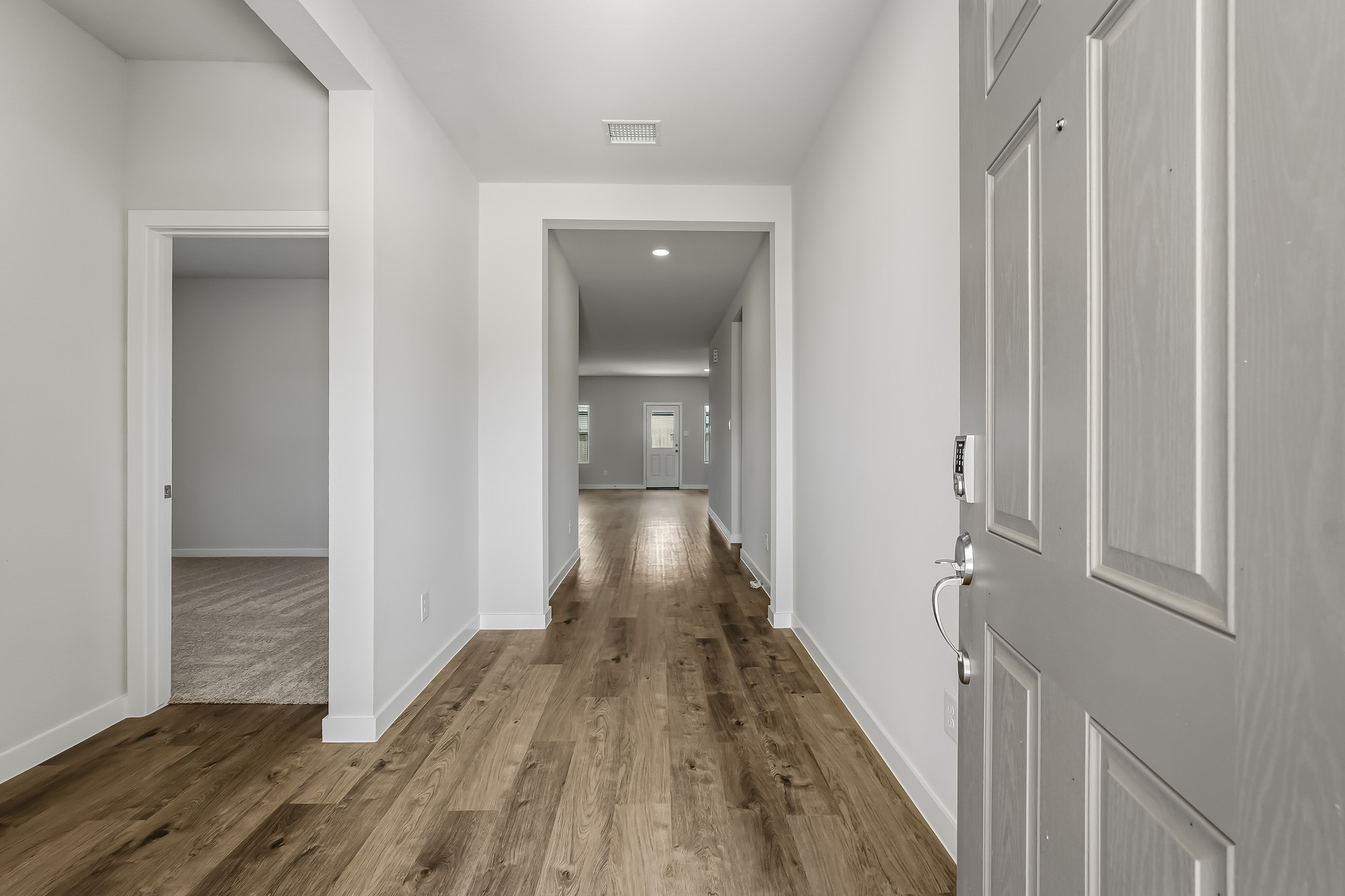 A hallway with white doors.