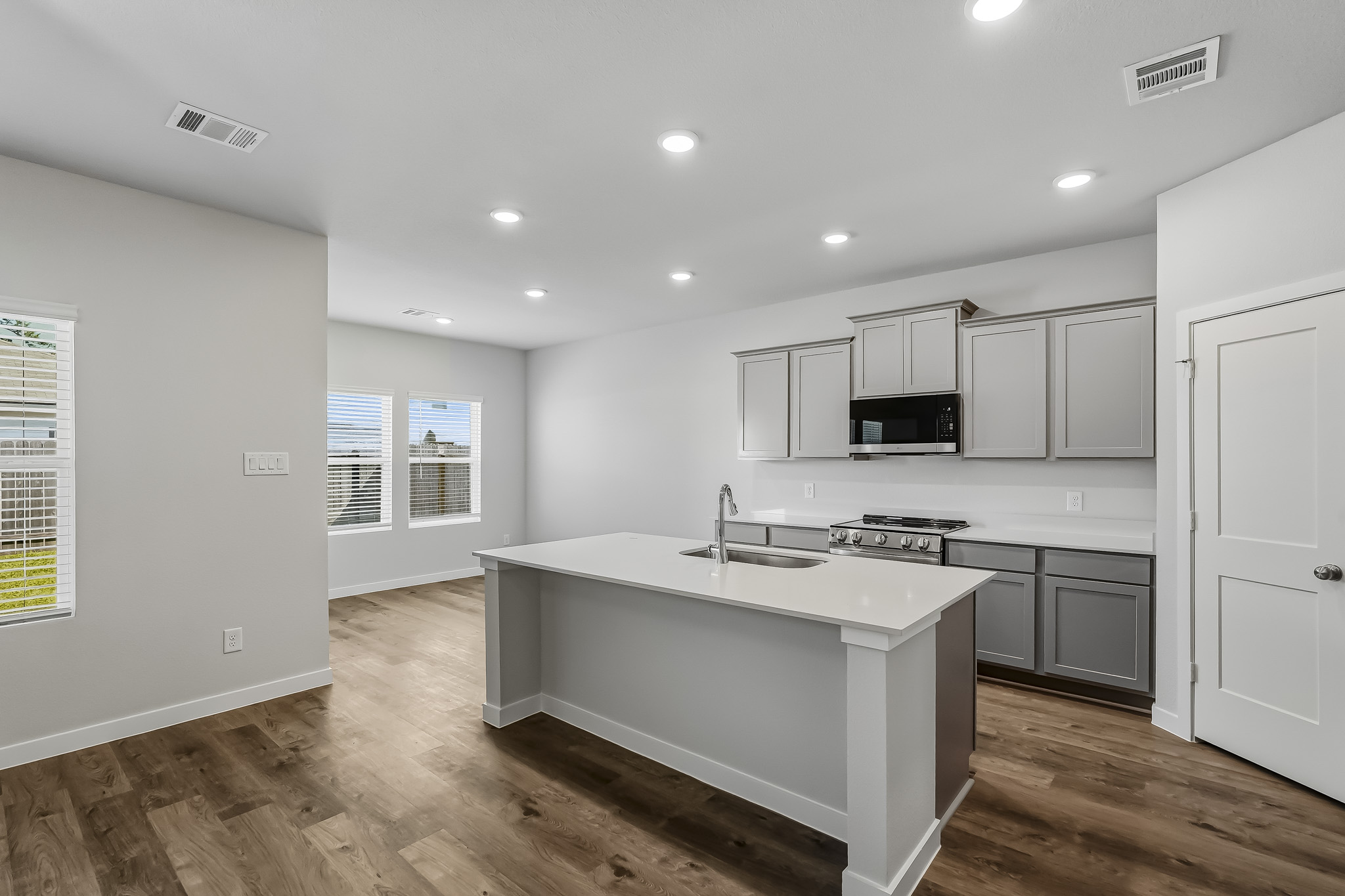 A kitchen with white cabinets.
