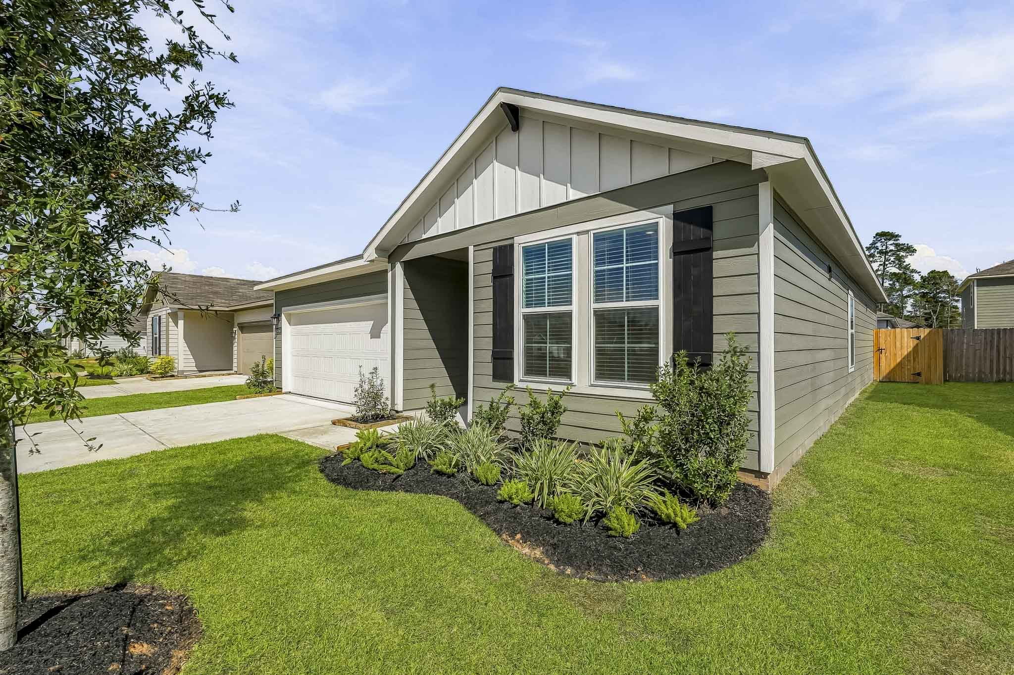 A house with a yard and a fence.