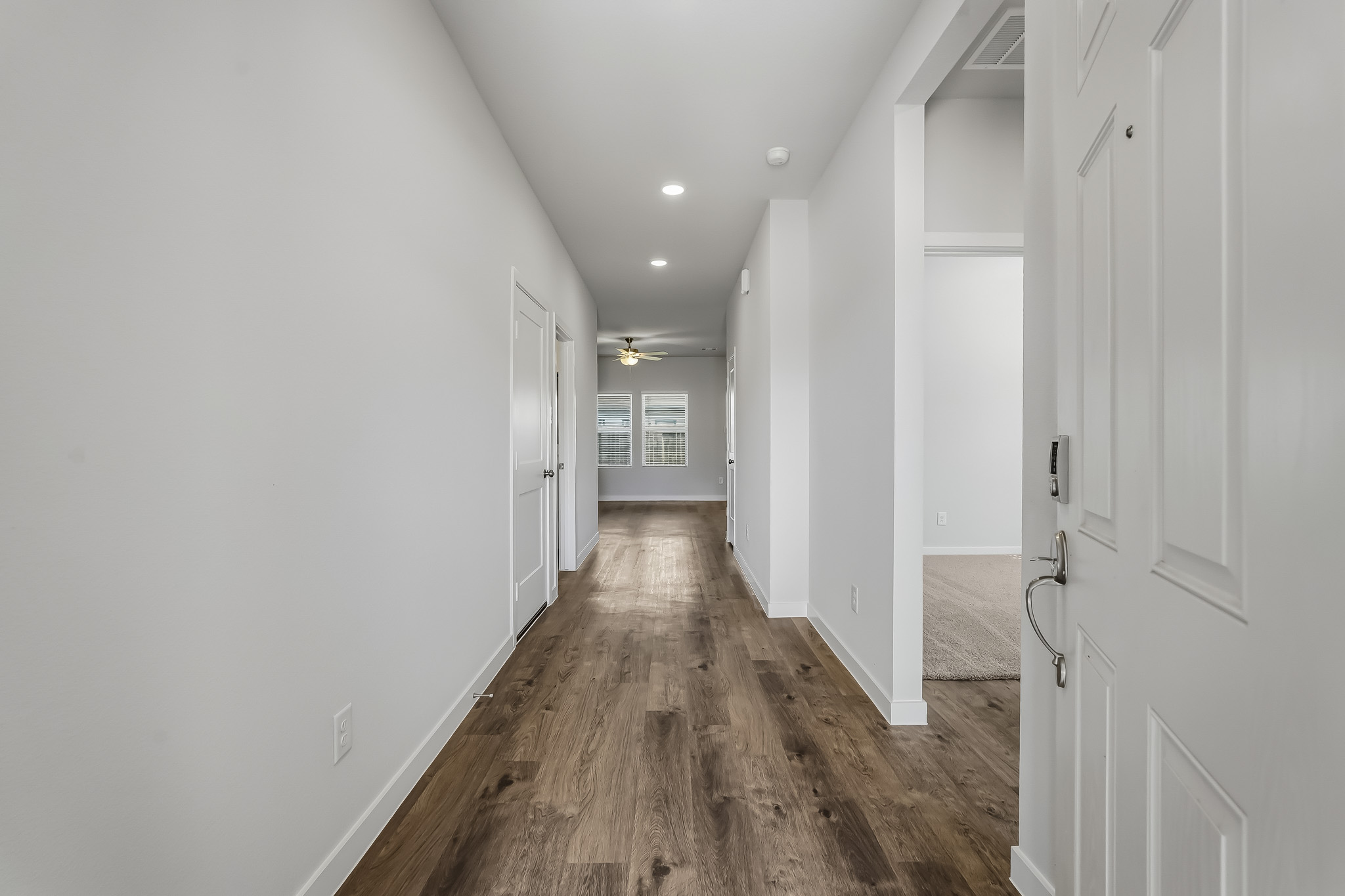 A hallway with white doors.