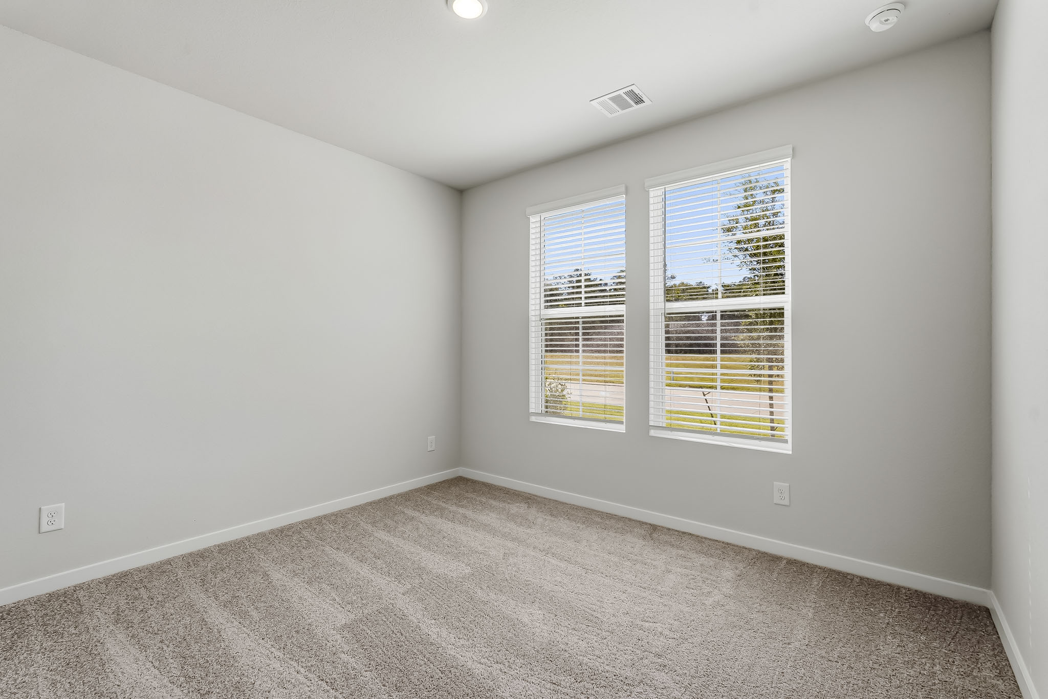 A room with a window and a carpet.