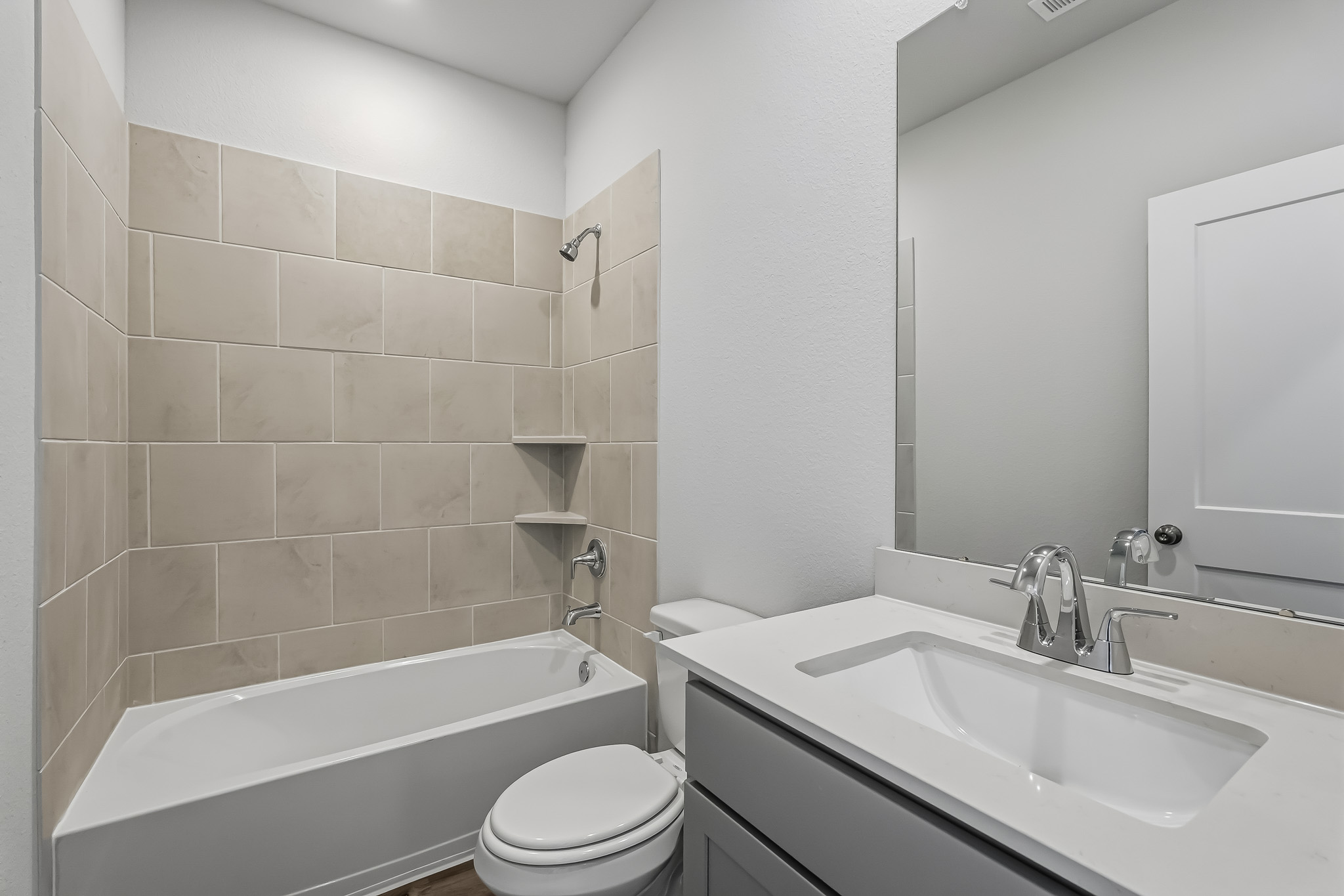 A bathroom with a tub sink and toilet.