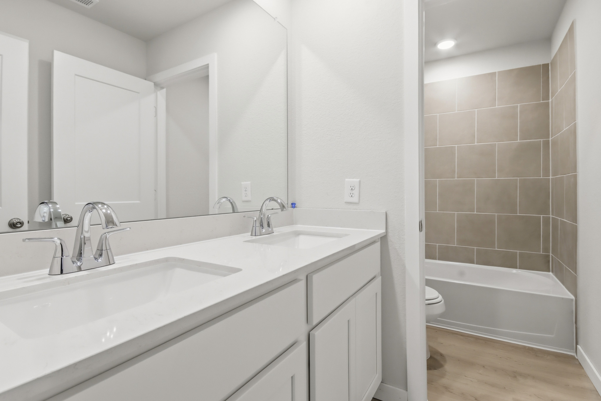 A bathroom with a tub sink and toilet.