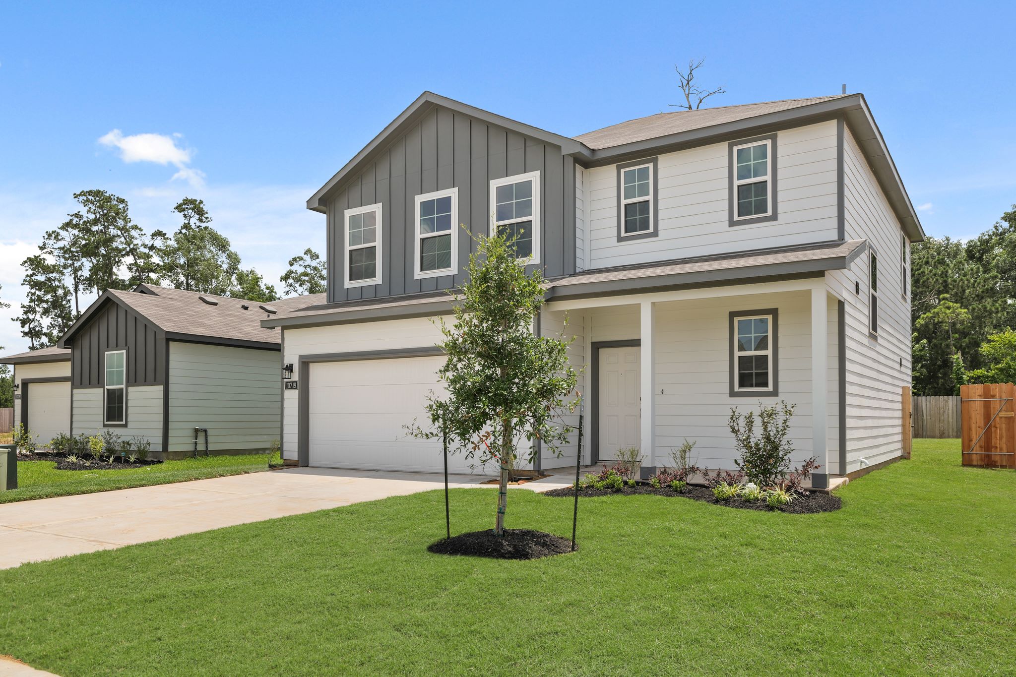 A house with a tree in the front yard.