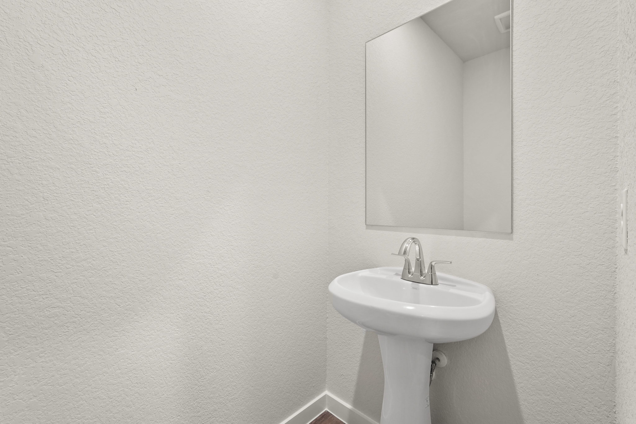 A bathroom with a mirror.