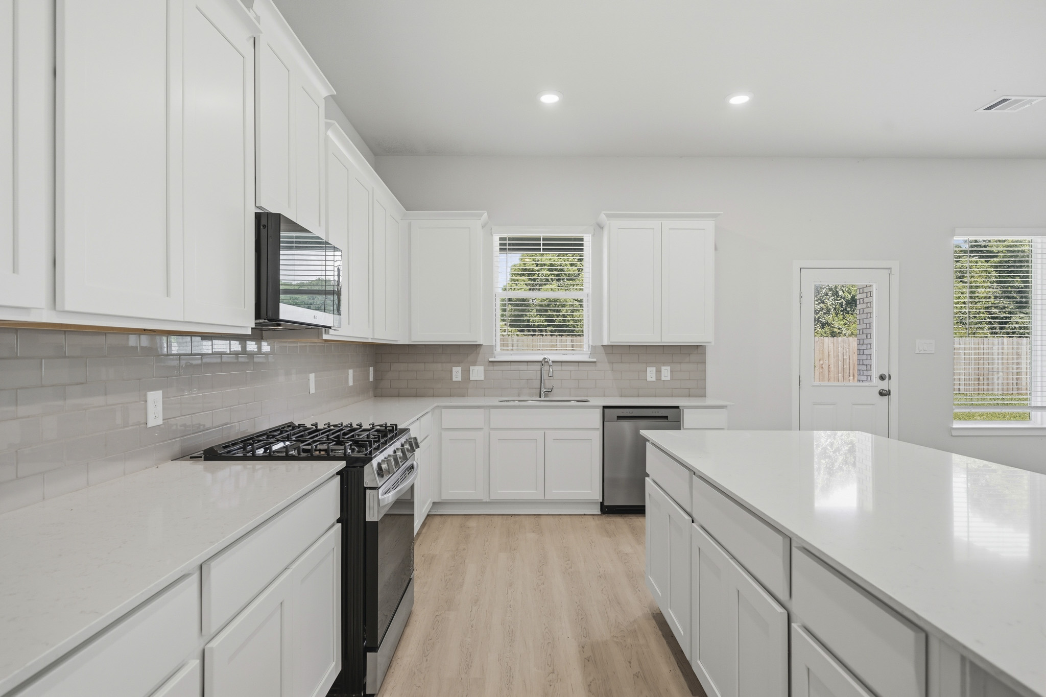 A kitchen with white cabinets.