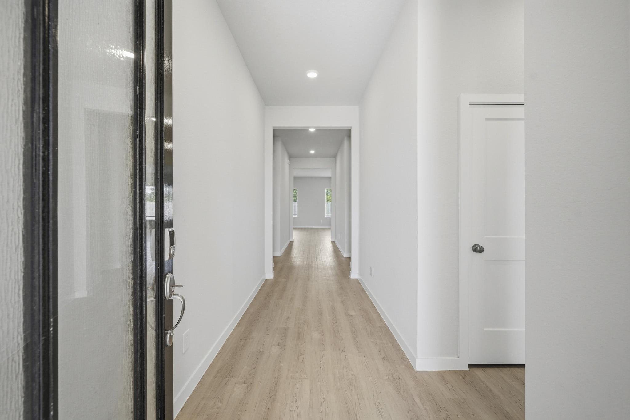 A hallway with white doors.
