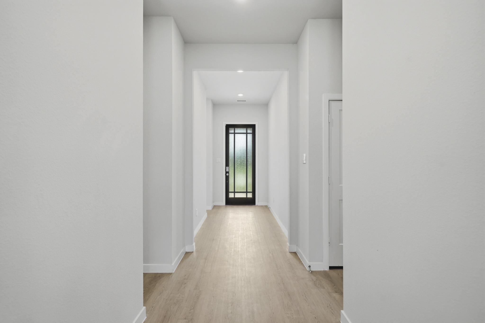 A hallway with white walls.