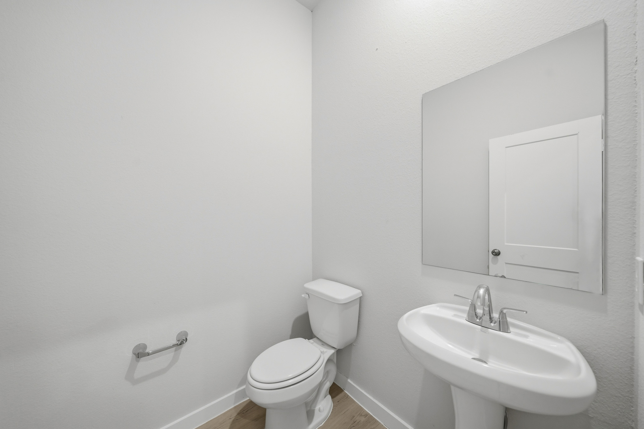 A bathroom with a toilet and sink.