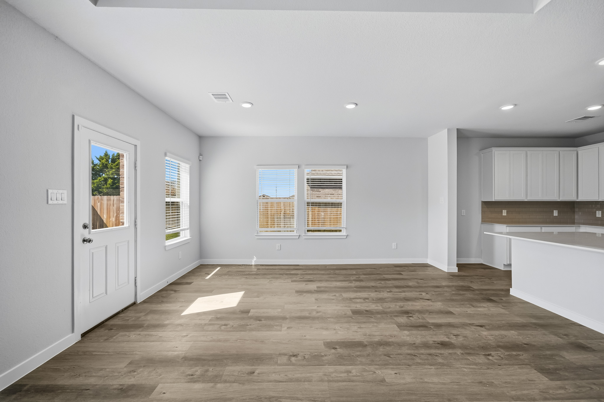 A room with white walls and a wood floor.