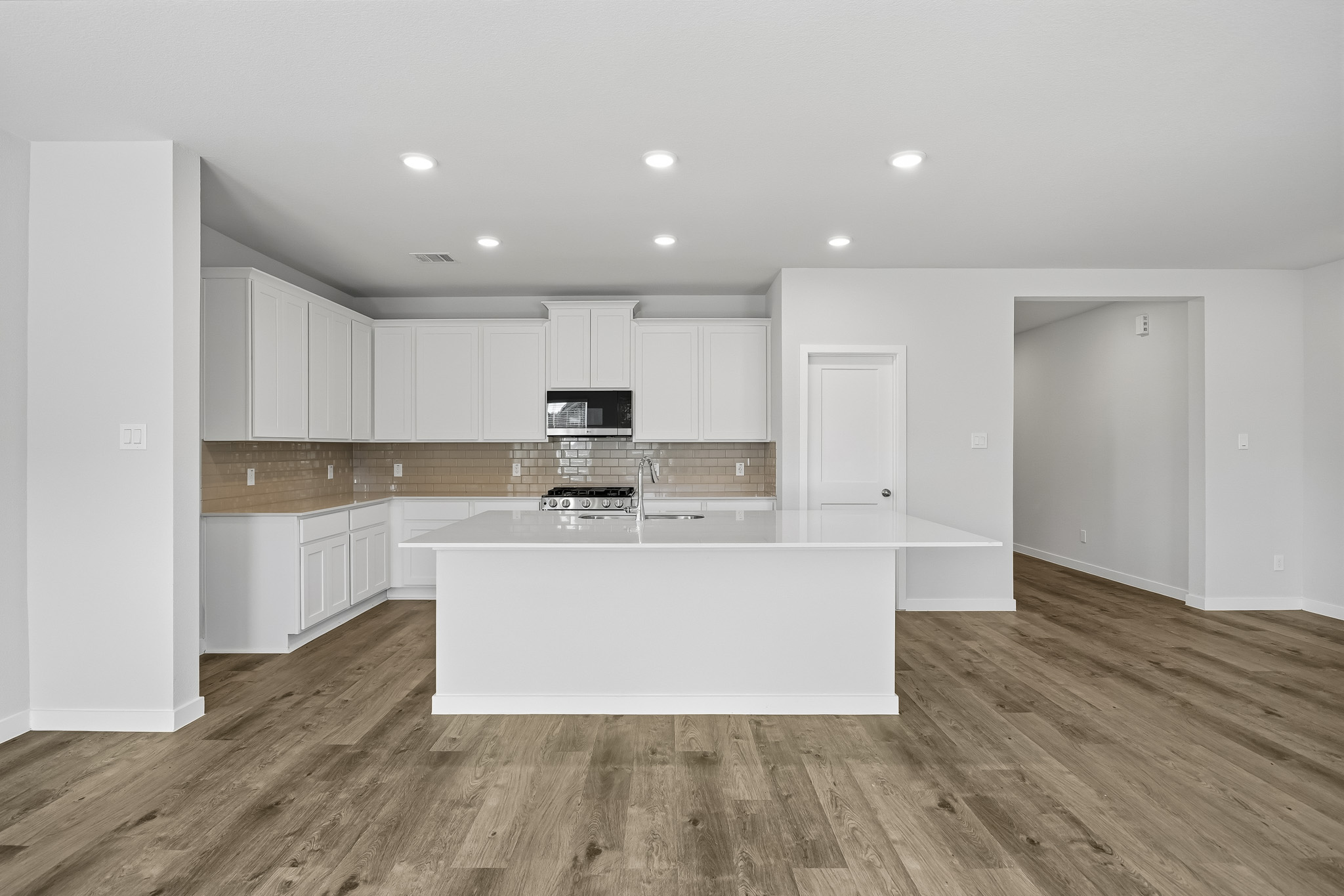 A kitchen with white cabinets.