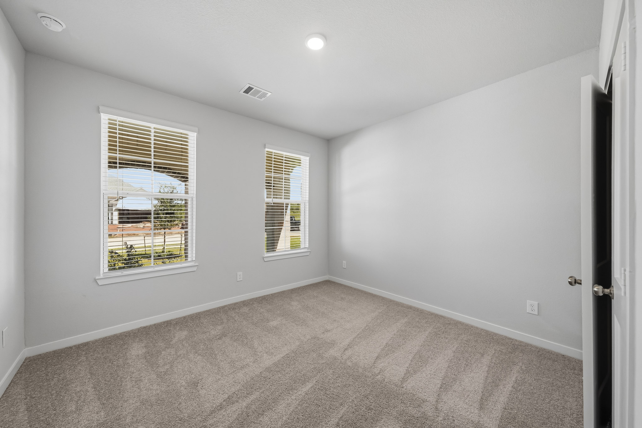 A room with a window and a door.
