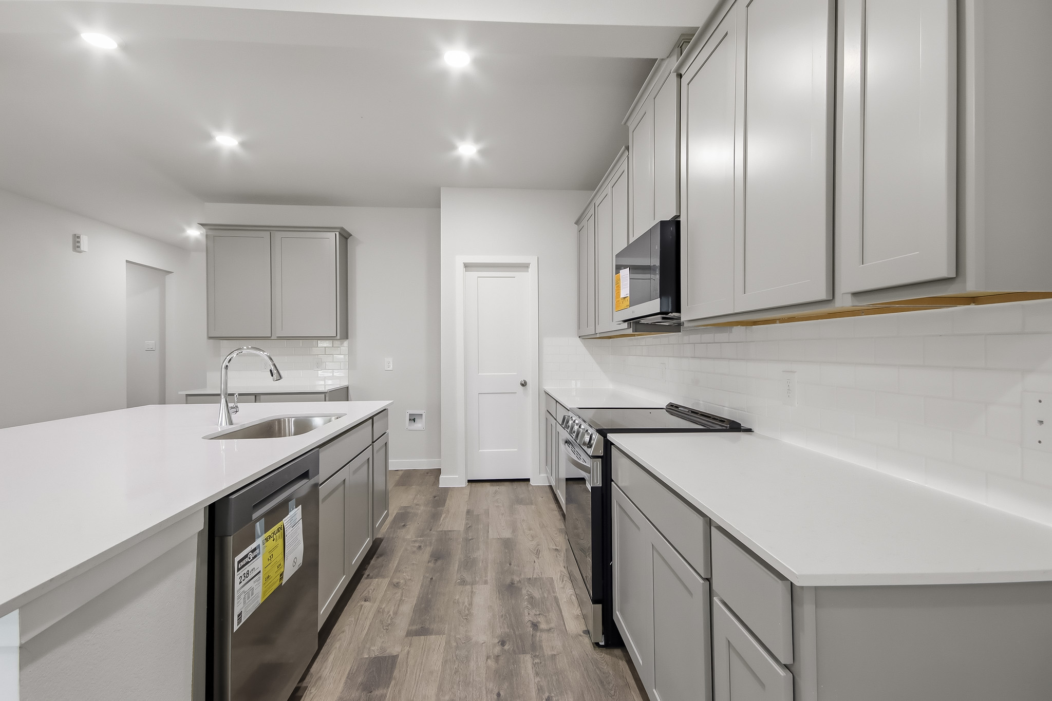 A kitchen with white cabinets.