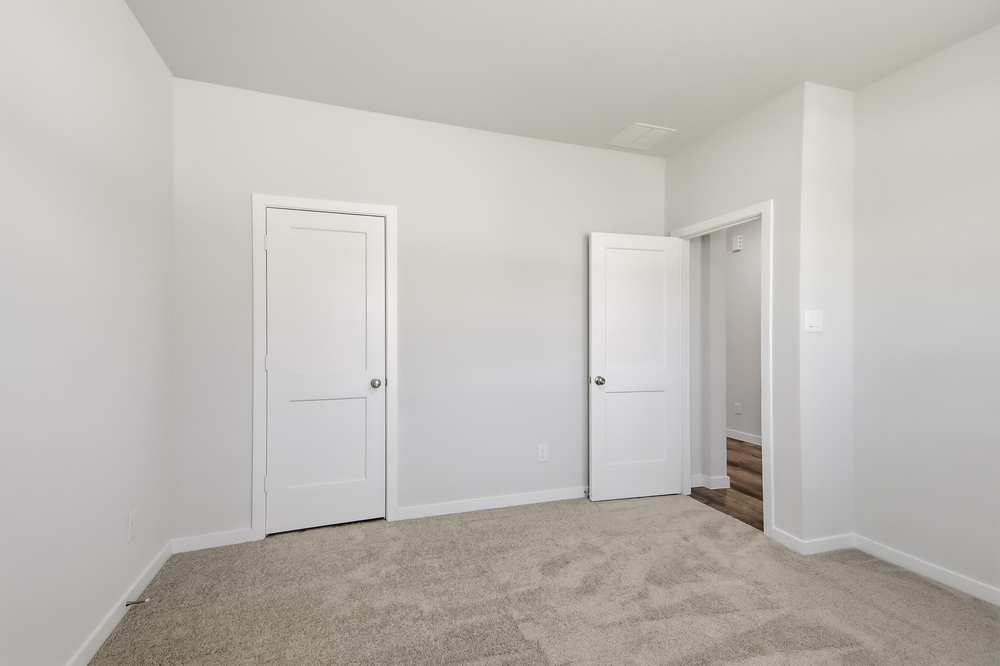 A hallway with white doors.