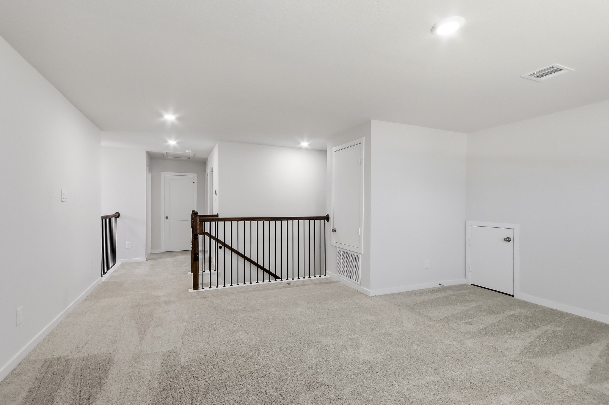 A room with a staircase and white walls.