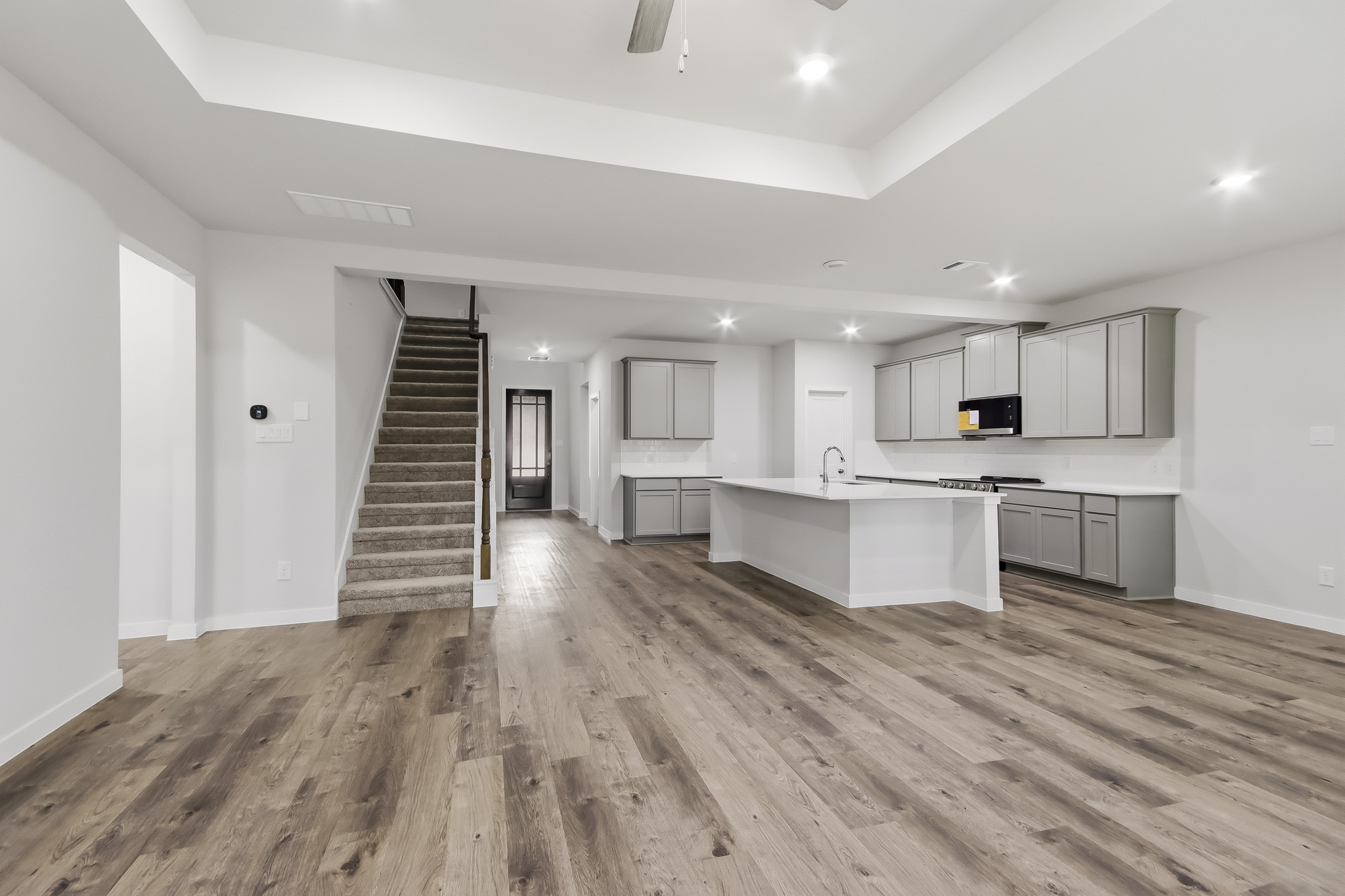 A large kitchen with white cabinets.