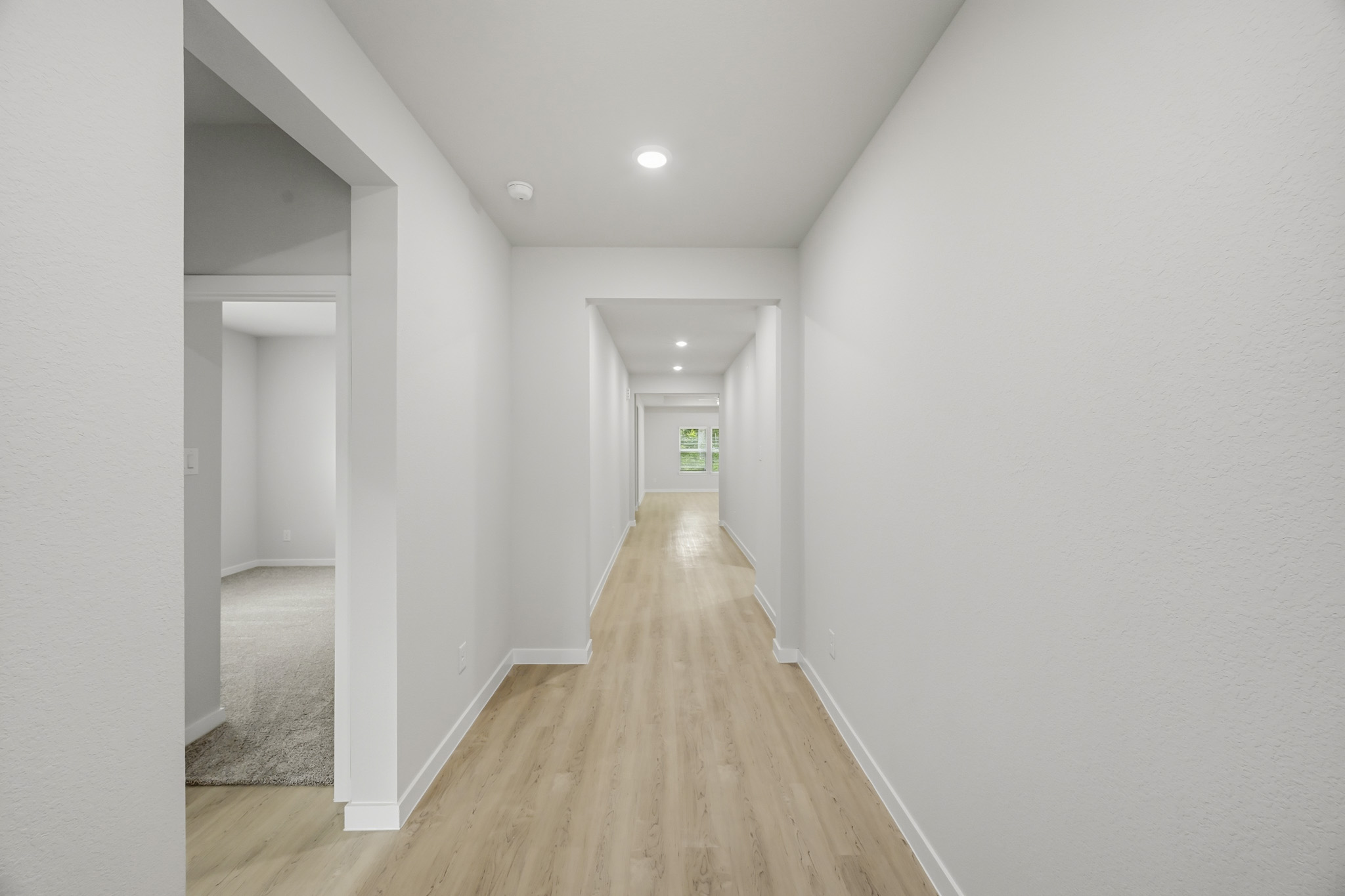 A hallway with white walls.