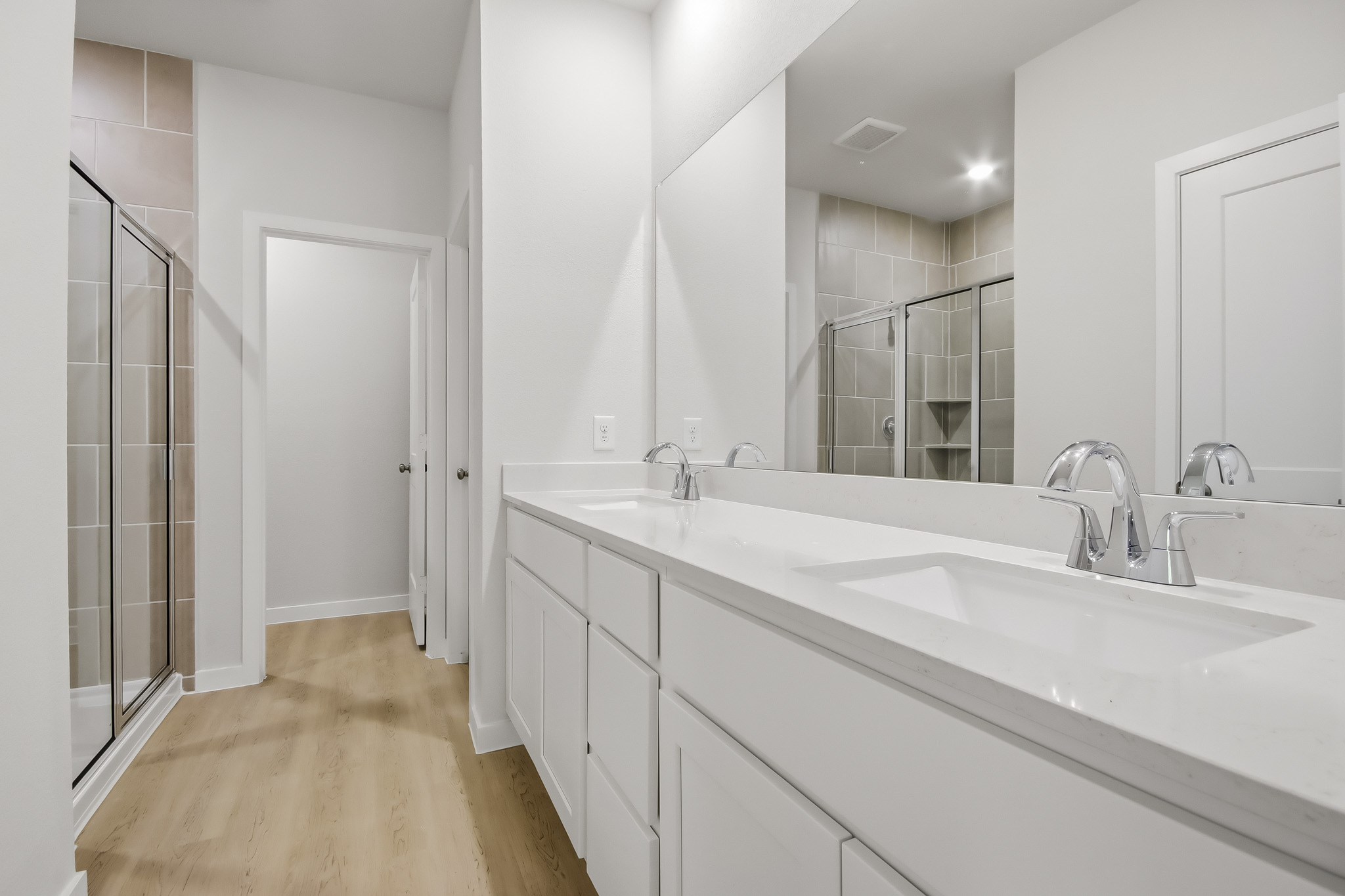 A bathroom with a large mirror.