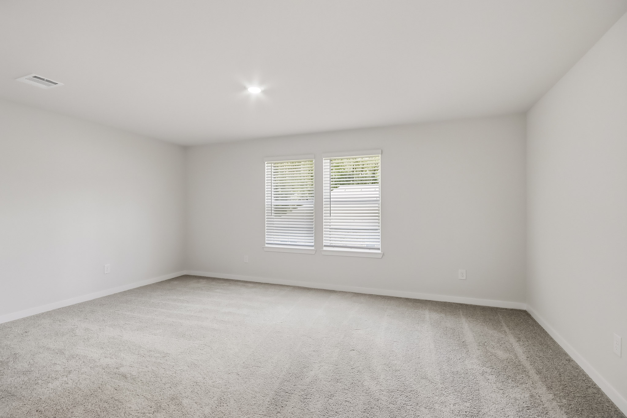 A room with a window and a carpet.