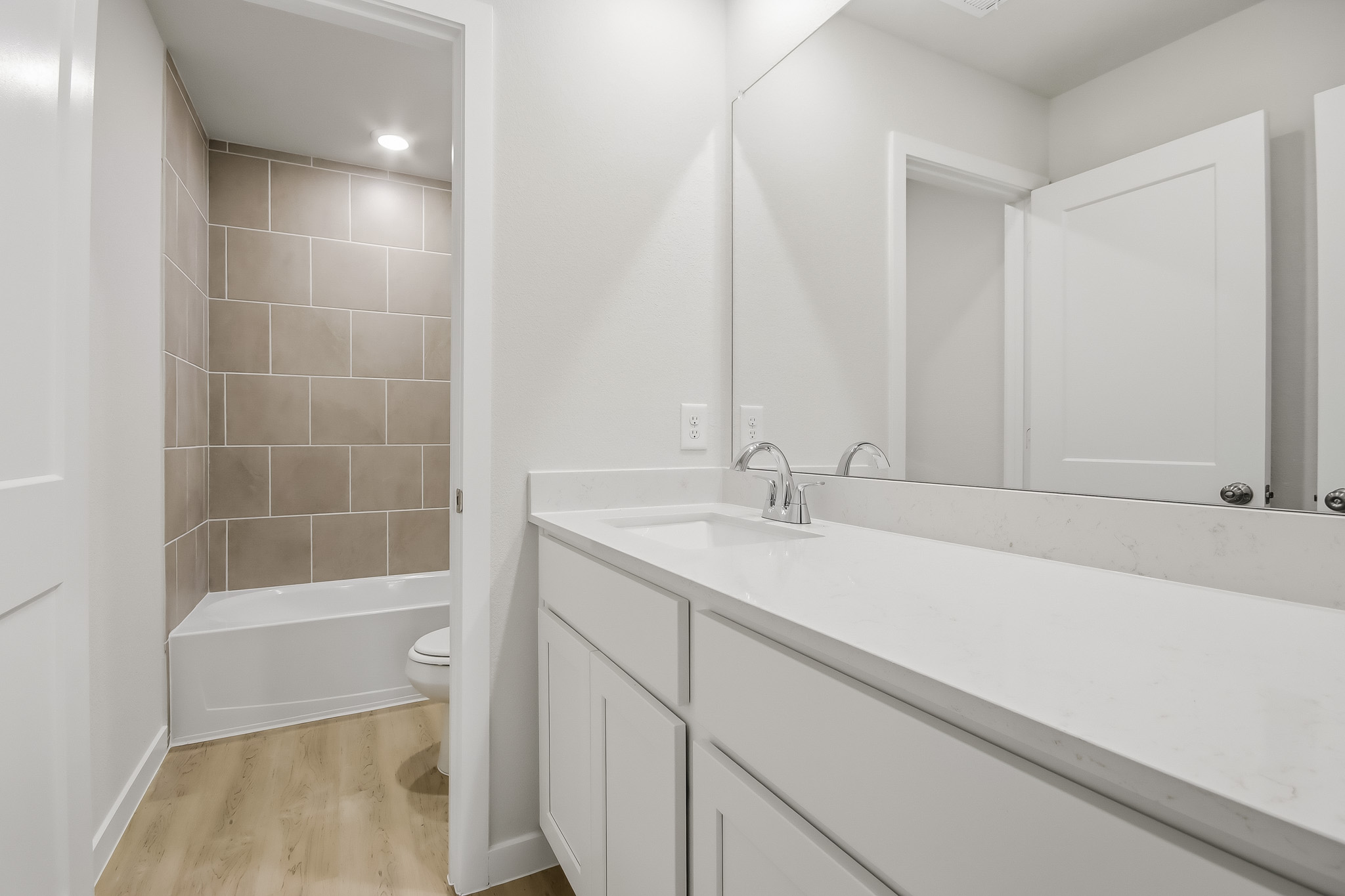A bathroom with a tub sink and toilet.