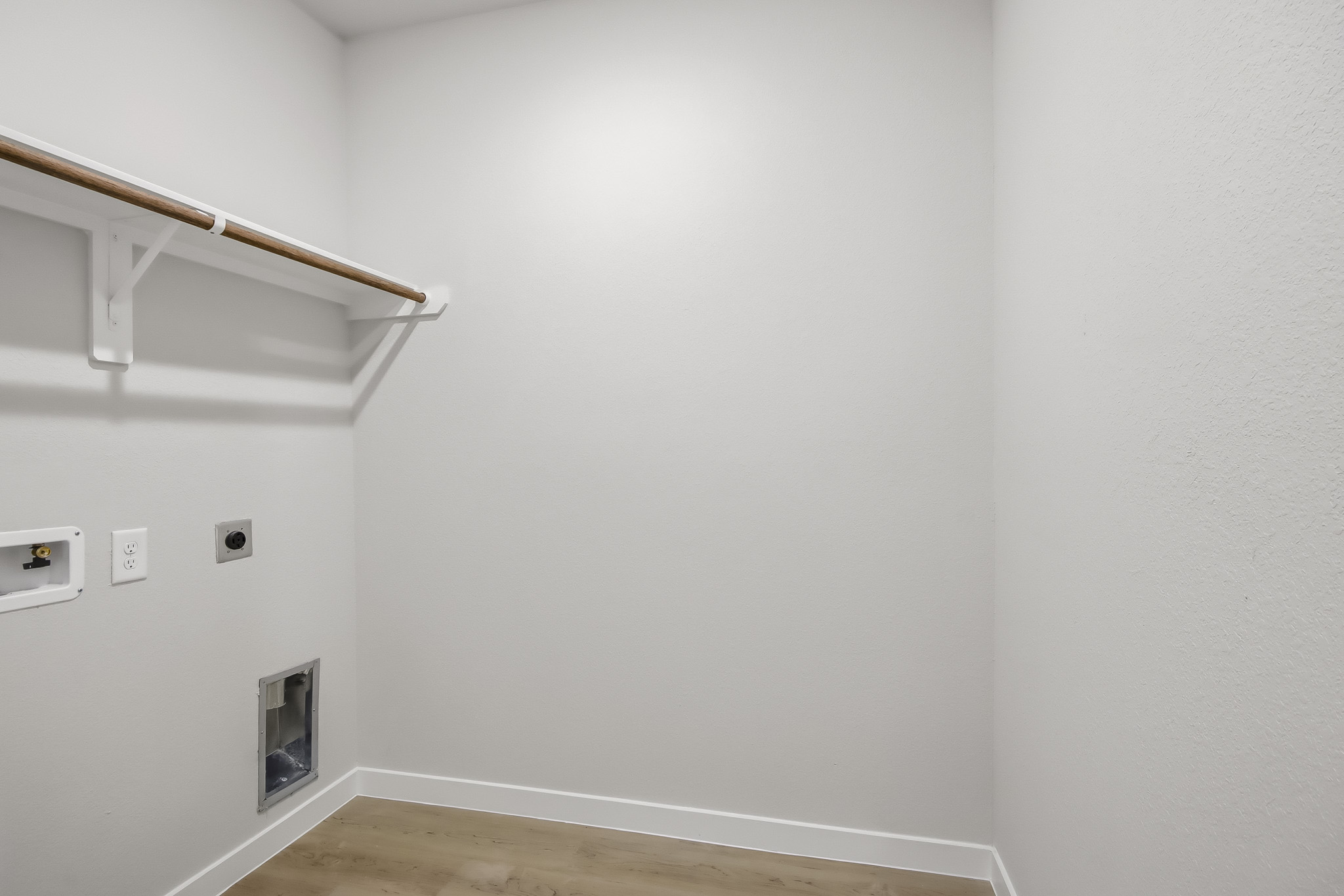 A white wall with a wood railing.