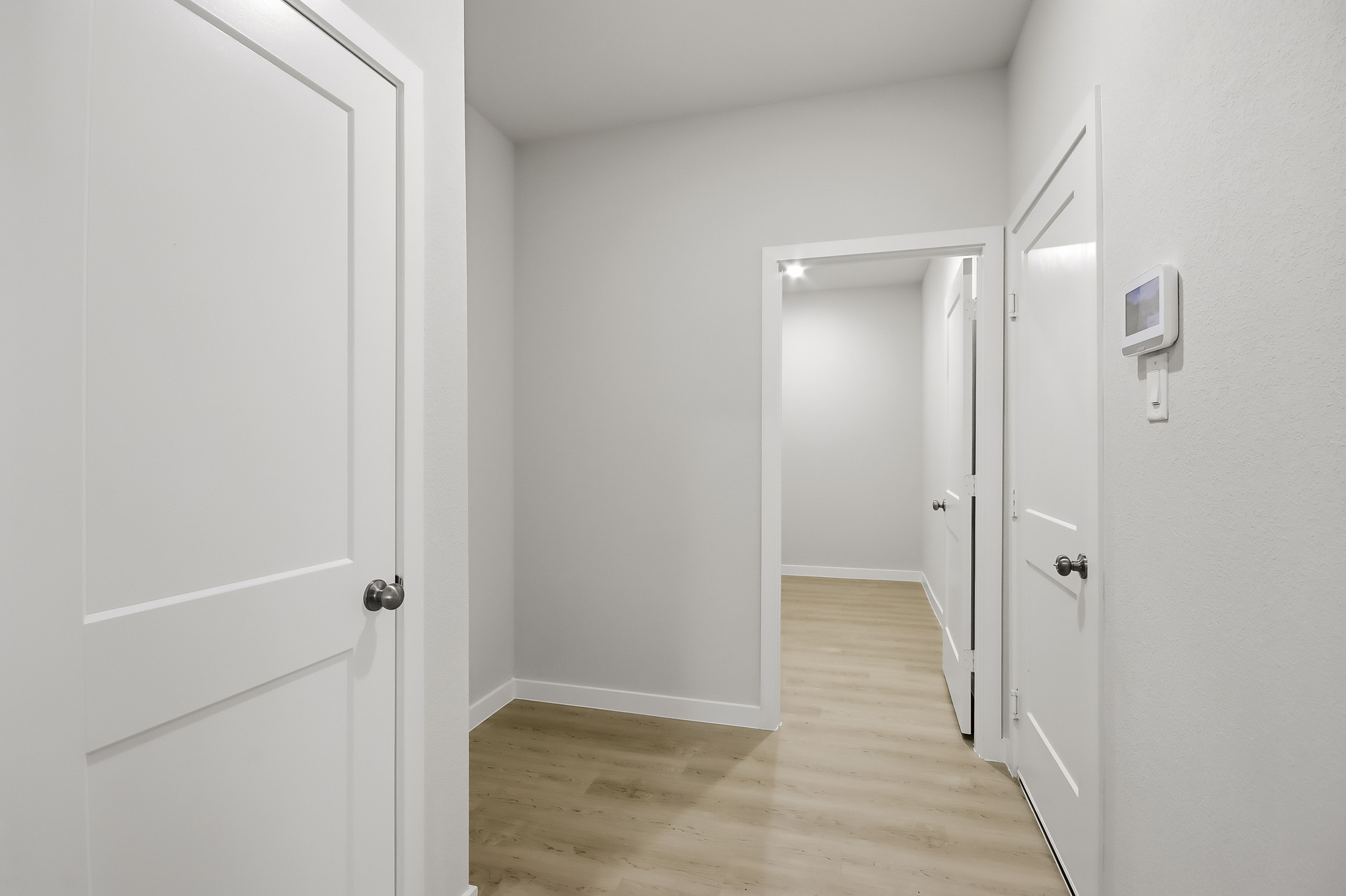 A hallway with white doors.