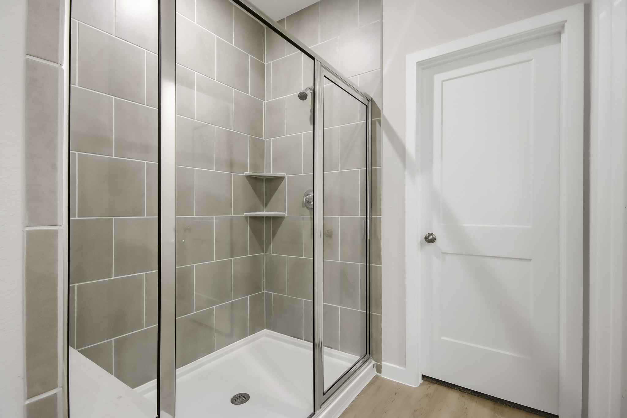 A shower with a glass door.