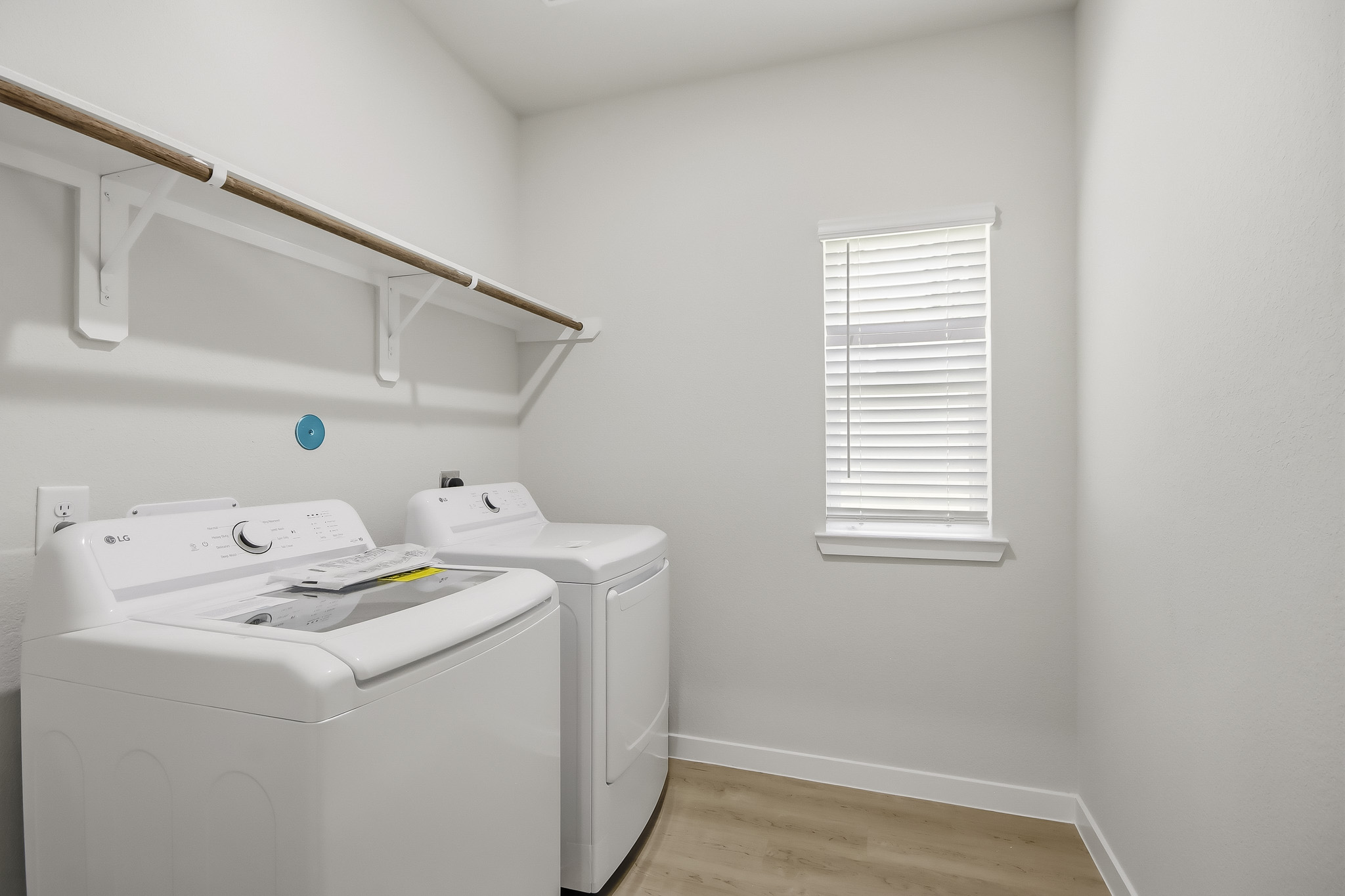 A room with a white wall and a white shelf with a white radiator and a white.