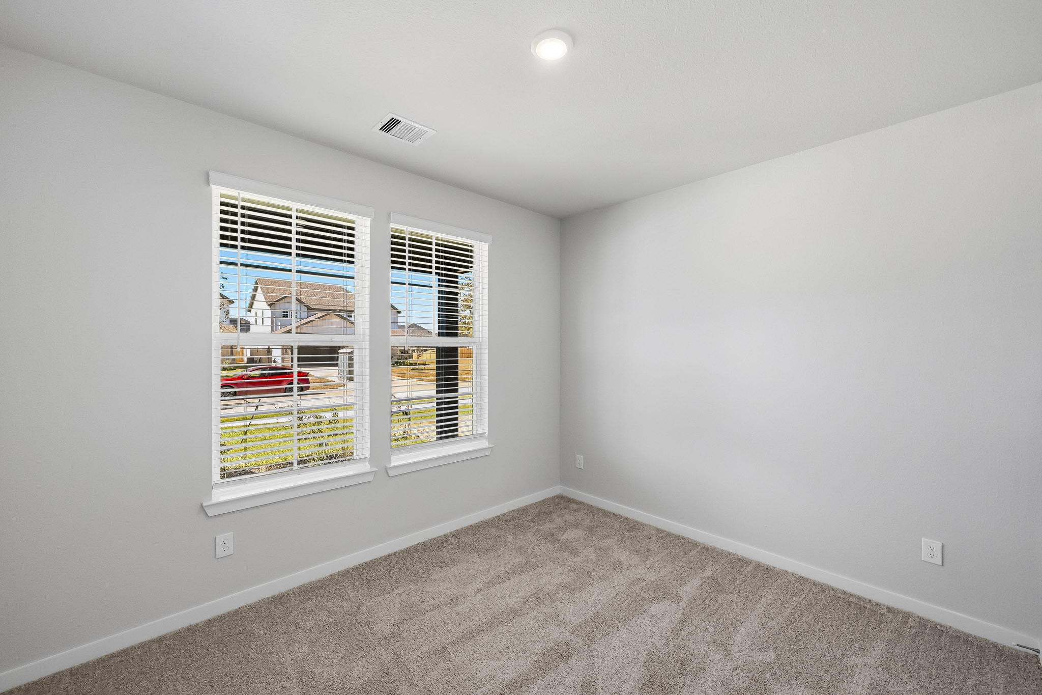 A room with a window and a carpet.