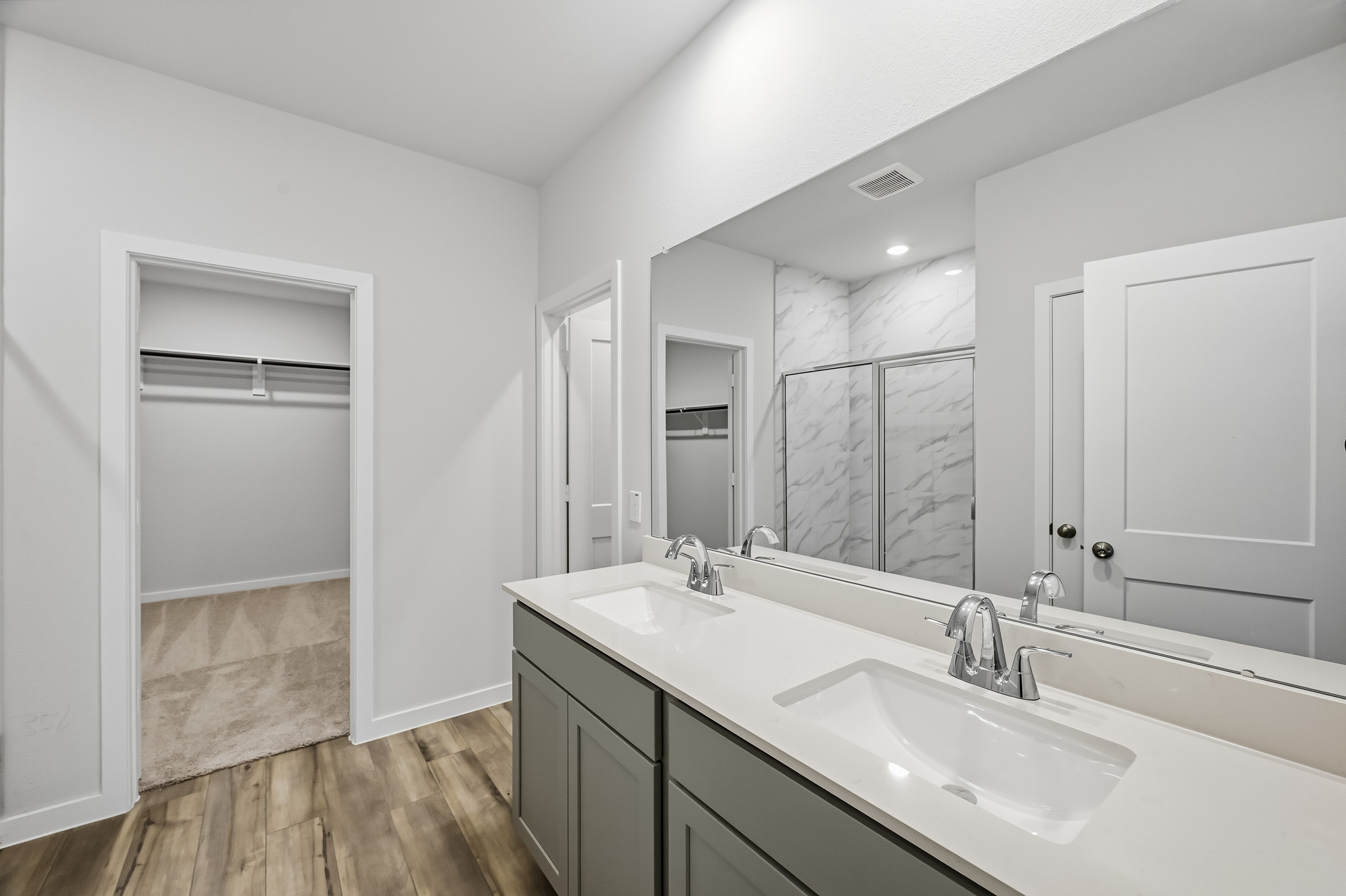 A bathroom with a large mirror.
