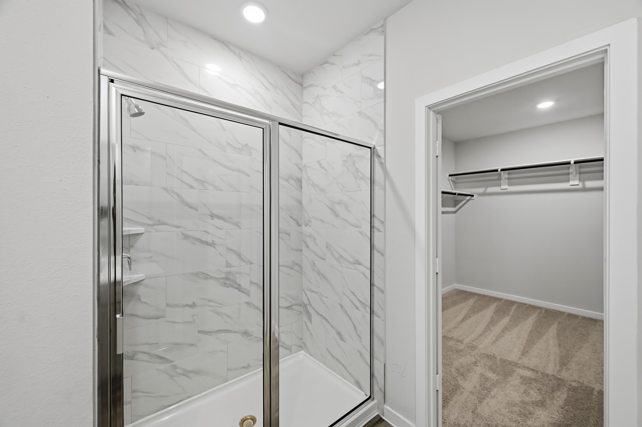 A shower with a glass door.