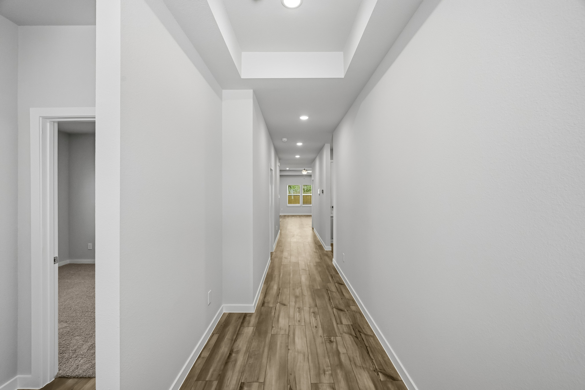 A long hallway with white walls.