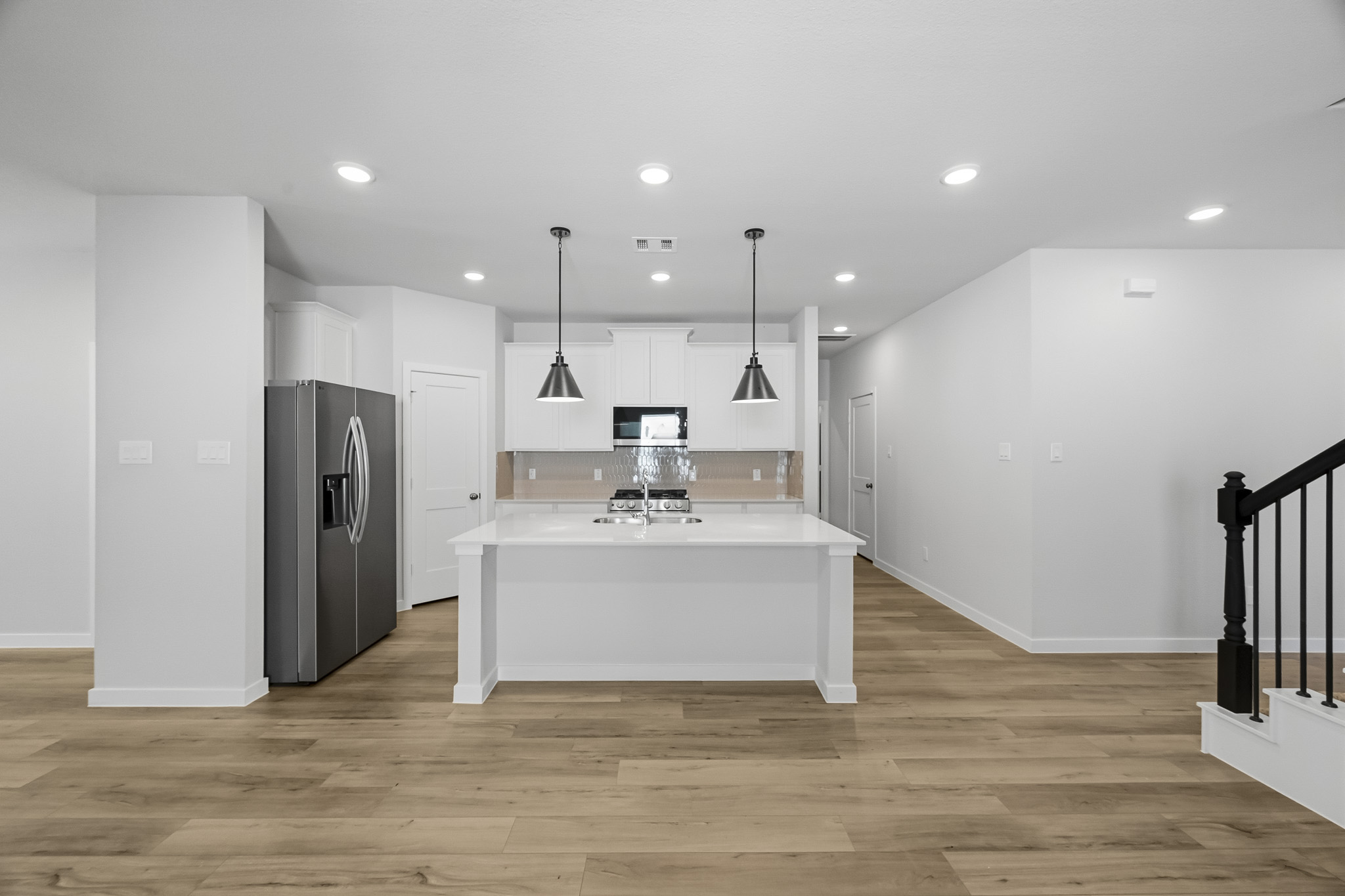 A kitchen with white cabinets.