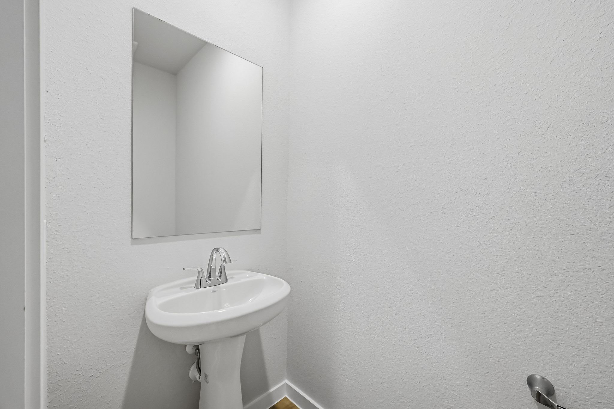 A bathroom with a mirror.